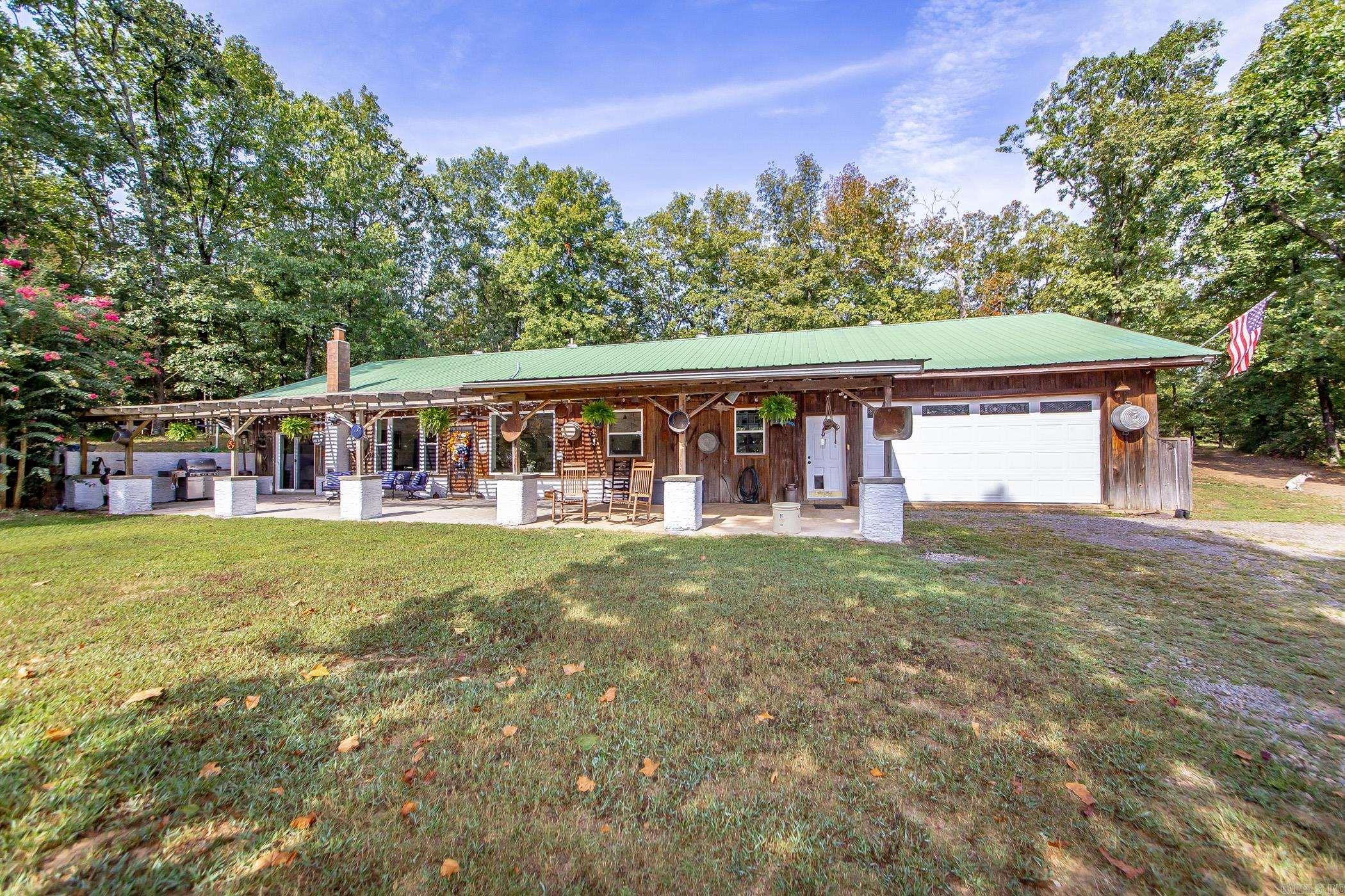 Tucked away in a peaceful and private setting, this 3-bedroom, 2-bath earth-sheltered home sits on 37 acres with a large, beautiful pond and plenty of space to roam. The open design features 9.5ā ceilings, a spacious office that could easily serve as a 4th bedroom, and thoughtful updates including geothermal heat and air with backup wood heater, new windows, flooring, concrete countertops, and recessed lighting. The master suite boasts a large steam shower and its own heater for extra comfort. A central heated and cooled garageācurrently used as a shopāplus a pantry and laundry room with utility sink add convenience. Outside, fruit and nut trees, a barn with water and electricity, and plenty of pasture make it ideal for horses or livestock. A one-of-a-kind property with modern comfort and country charm!