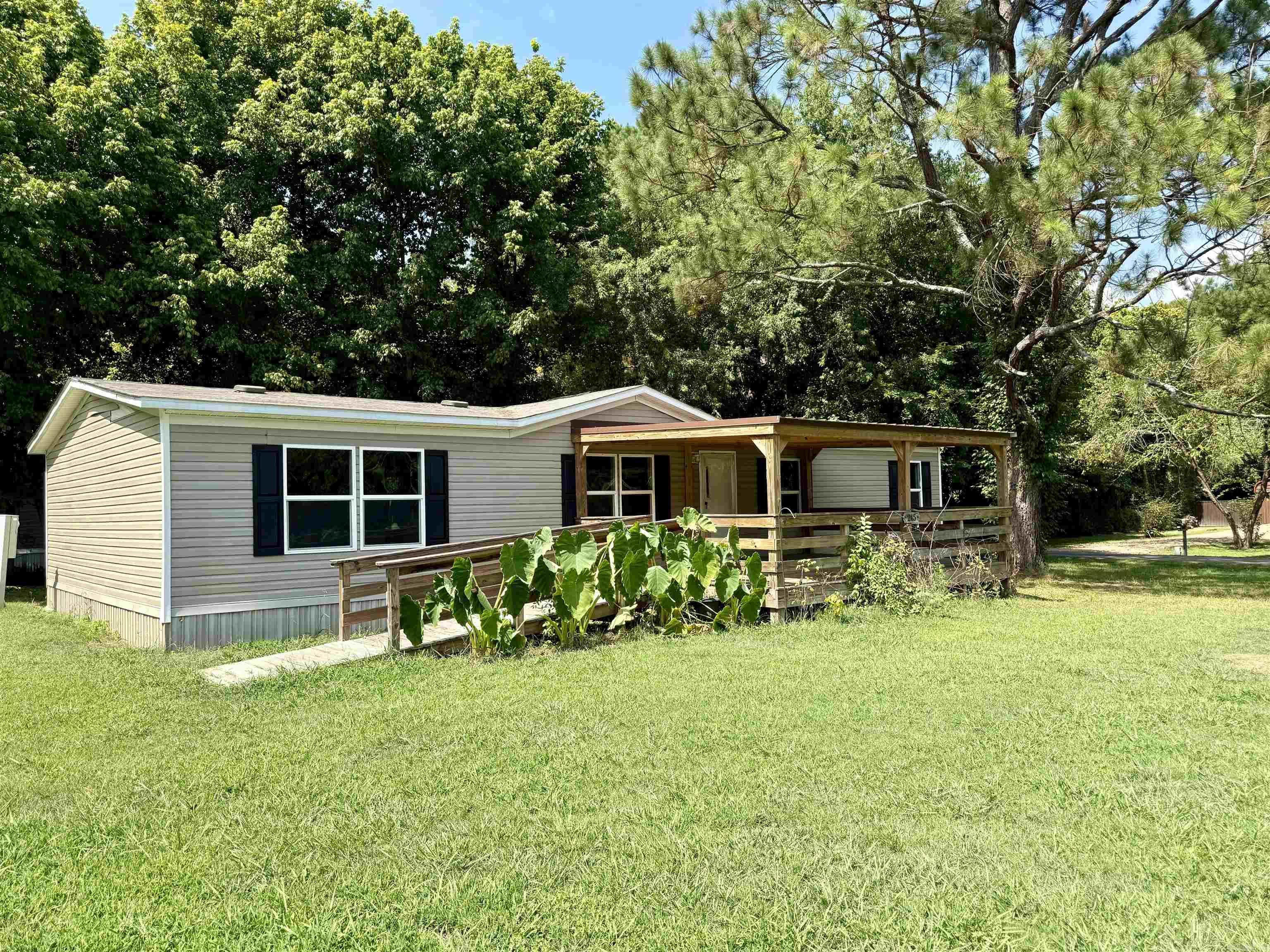 Very well-kept and in like-new condition, this 2023 double-wide mobile home on a .32 acre tract in Rainbow Island offers 1,568 sq ft of comfortable living space with 4 bedrooms, 2 baths, and 2 living areas or optional den/dining room. The spacious laundry room adds convenience, and the home is all-electric with all appliances included, making it completely move-in ready. Enjoy the large covered front porch with ramp, perfect for relaxing outdoors. Sitting on a desirable corner lot across the road from the Little Red River, this property awaits its new owner!