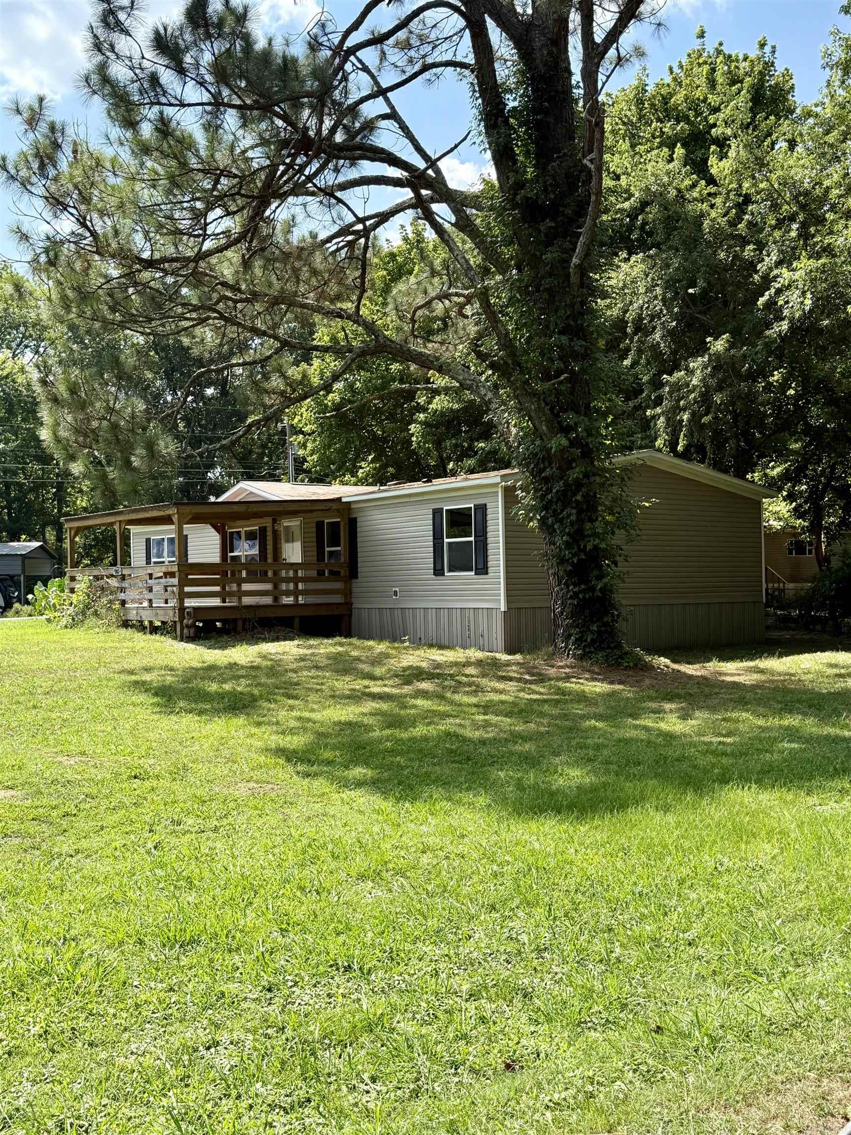Very well-kept and in like-new condition, this 2023 double-wide mobile home on a .32 acre tract in Rainbow Island offers 1,568 sq ft of comfortable living space with 4 bedrooms, 2 baths, and 2 living areas or optional den/dining room. The spacious laundry room adds convenience, and the home is all-electric with all appliances included, making it completely move-in ready. Enjoy the large covered front porch with ramp, perfect for relaxing outdoors. Sitting on a desirable corner lot across the road from the Little Red River, this property awaits its new owner!