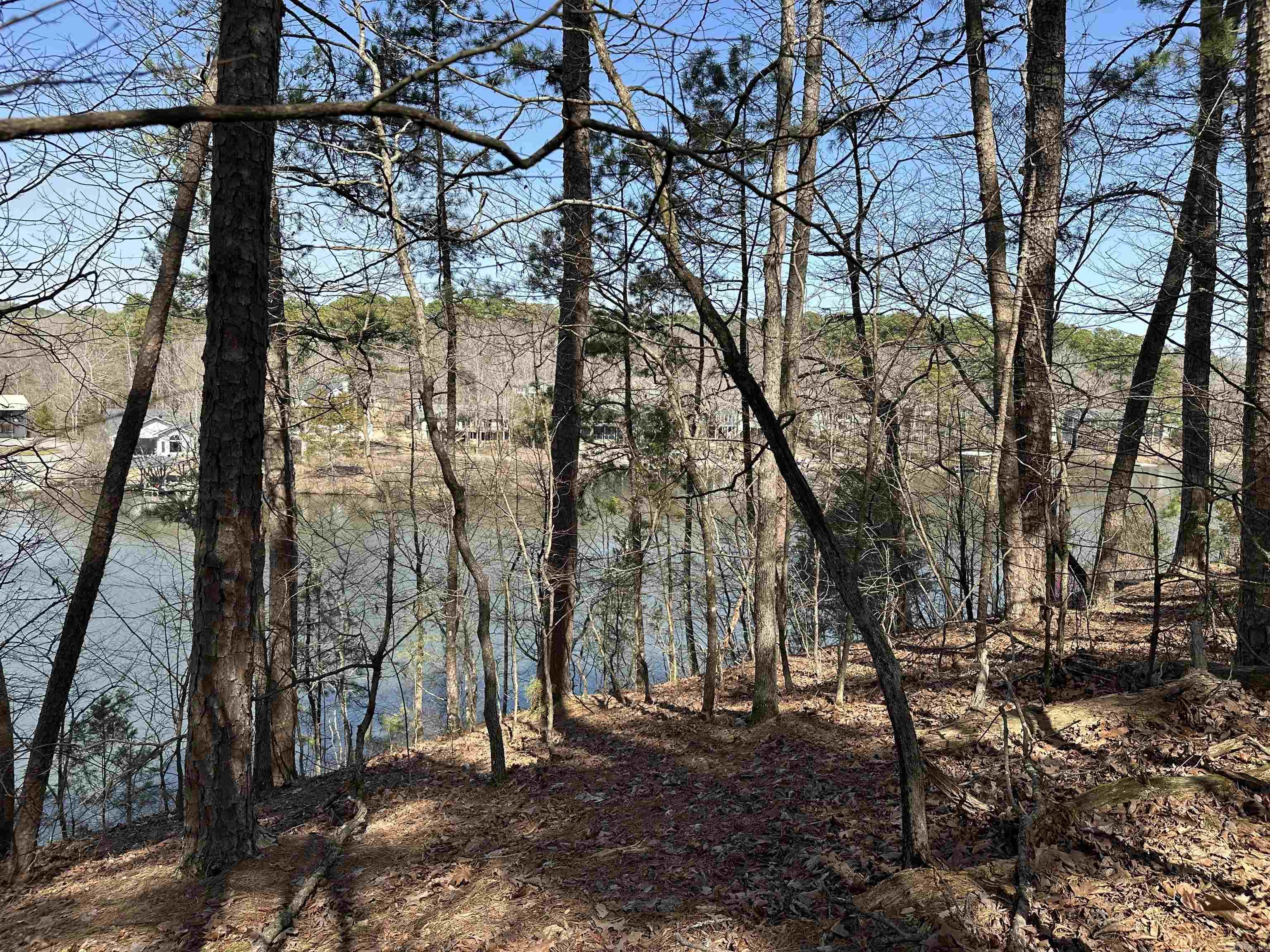 LAKE LOT High and Dry lot with incredible views of the mountains and Lake Pineda. Mostly level lot with a backyard. Natural stone seawall with 68 feet of lake frontage, great fishing, large upscale homes on the cul de sac street, Glazy Peau gate for convenient entrance to the village. Come build your dream home and live in the largest gated community in North America and enjoy the beautiful scenery, 9 golf courses, 11 lakes, pickleball courts, tennis courts, miles of hiking trails, workout facilities, numerous event facilities.