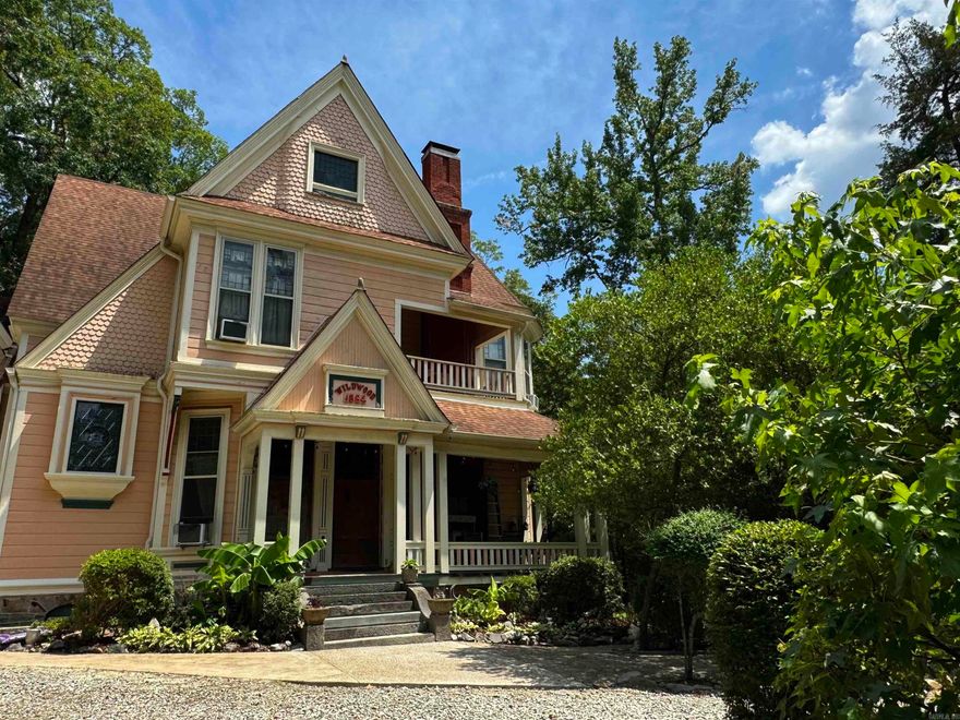 Established in 1884. Perfectly kept custom Victorian on Park Avenue. A pioneer of the towns original home place. Towering 4 stories, lowest level is full kitchen, living area, fireplace, ensuite bedroom plus another bedroom or office & laundry. 2nd formal entry level with foyer, 3 more fireplace, 2 parlors, dining, butlers pantry, dumb waiter, bedroom, 1/2 bath & 2 covered porches. 3rd level are 5 ensuite bedrooms, foyer & 2 private balconies with mountain & pristine garden views. 4th level is partially finished with 4 more large rooms not included in square footage! Incredible Formal Staircase with hand carved wood work & coffered veneer ceiling plus daily use secondary stair that services all 4 stories. Multiple types of heat & cooling sources. Electric is upgraded breakers. Roof is Architectural shingle. Enjoy as a private residence or continue the perfect legacy of a 20+ year Bed & Breakfast. Stunning grounds, ample parking. Located at the top of Historic Hot Springs National Park with hiking trails adjacent on a 1 acre corner lot. $879,000 is real estate only. Turn Key Business offered at $925,000. mls#24043926
