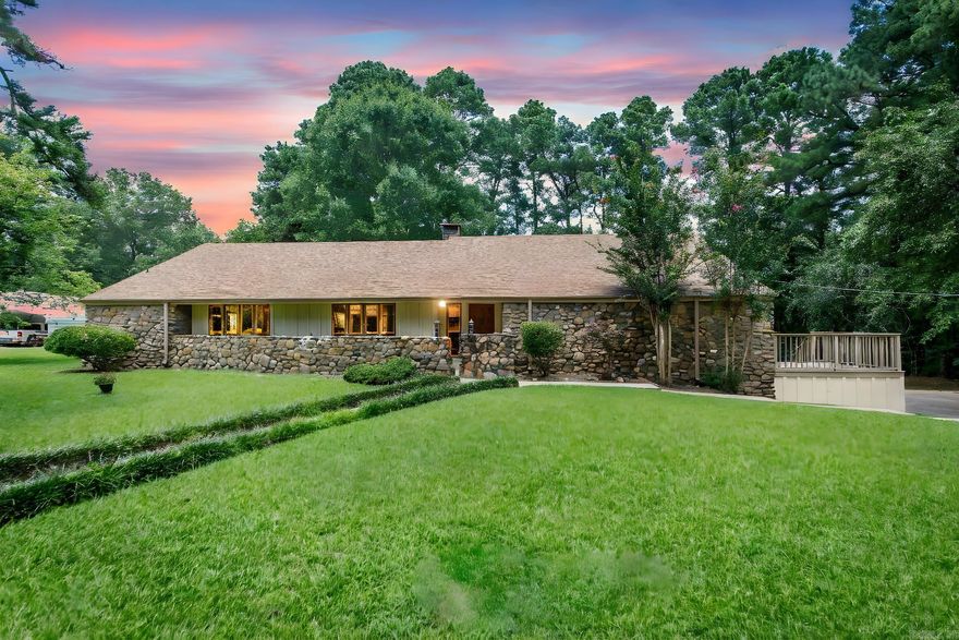 Welcome to 1520 Pine Drive, Ashdown, AR—a residence that harmoniously blends comfort and elegance with a touch of rustic charm. This meticulously maintained property features an array of custom upgrades that emphasize both functionality and aesthetic appeal. This custom MID-Century Home was Architecturally Designed by Little Rock Architect John D. Jarrard - specifically built by Charlie Newton (MAC) McCollum who was very interested in conservation and the environment.  Completed in 1977, this home has remained in family ownership ever since. This home was built with Passive Solar, so in the spring & fall, when the windows are open, the Southwest prevailing winds blow over the house which creates a suction of the Hot Air out through the clerestory windows. Exterior facade showcases a timeless design with a generous application of hand picked river rock that extends a warm invitation. The property is framed by a lush, manicured lawn, and wooded property line provides privacy without detracting from the scenic vistas of the surrounding neighborhood. The home's high-end Pella crank-out Windows which infuse the living spaces w/ an abundance of natural light.