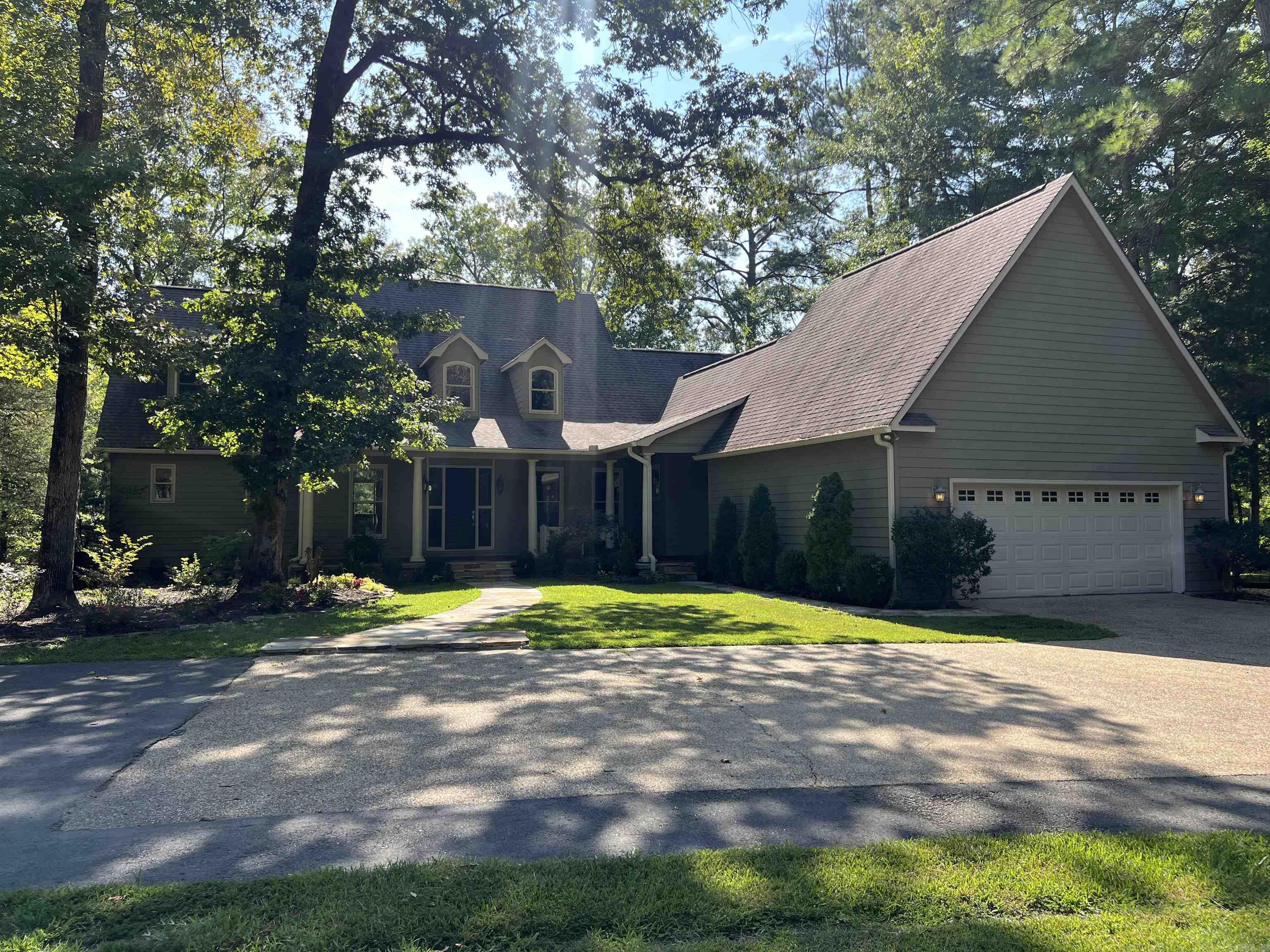 This immaculately maintained two-story home seamlessly blends modern elegance with rustic charm. Featuring original 120-year-old barn wood paneling and a warm and inviting fireplace, this house exudes timeless warmth and character. Set on four beautifully landscaped acres, the property offers stunning views of a serene 12-acre stocked pond, providing a peaceful backdrop. The kitchen features a large tiled island, pantry, stainless steel appliances including a wine fridge and abundant cabinets for storage. The spacious primary suite is located downstairs and features walk-in closet, double sinks in the vanity, a large garden tub and a beautiful tiled shower. Upstairs you will find three guest bedrooms with ample closet space and two full bathrooms. If you are looking for peaceful serene living, WELCOME HOME!