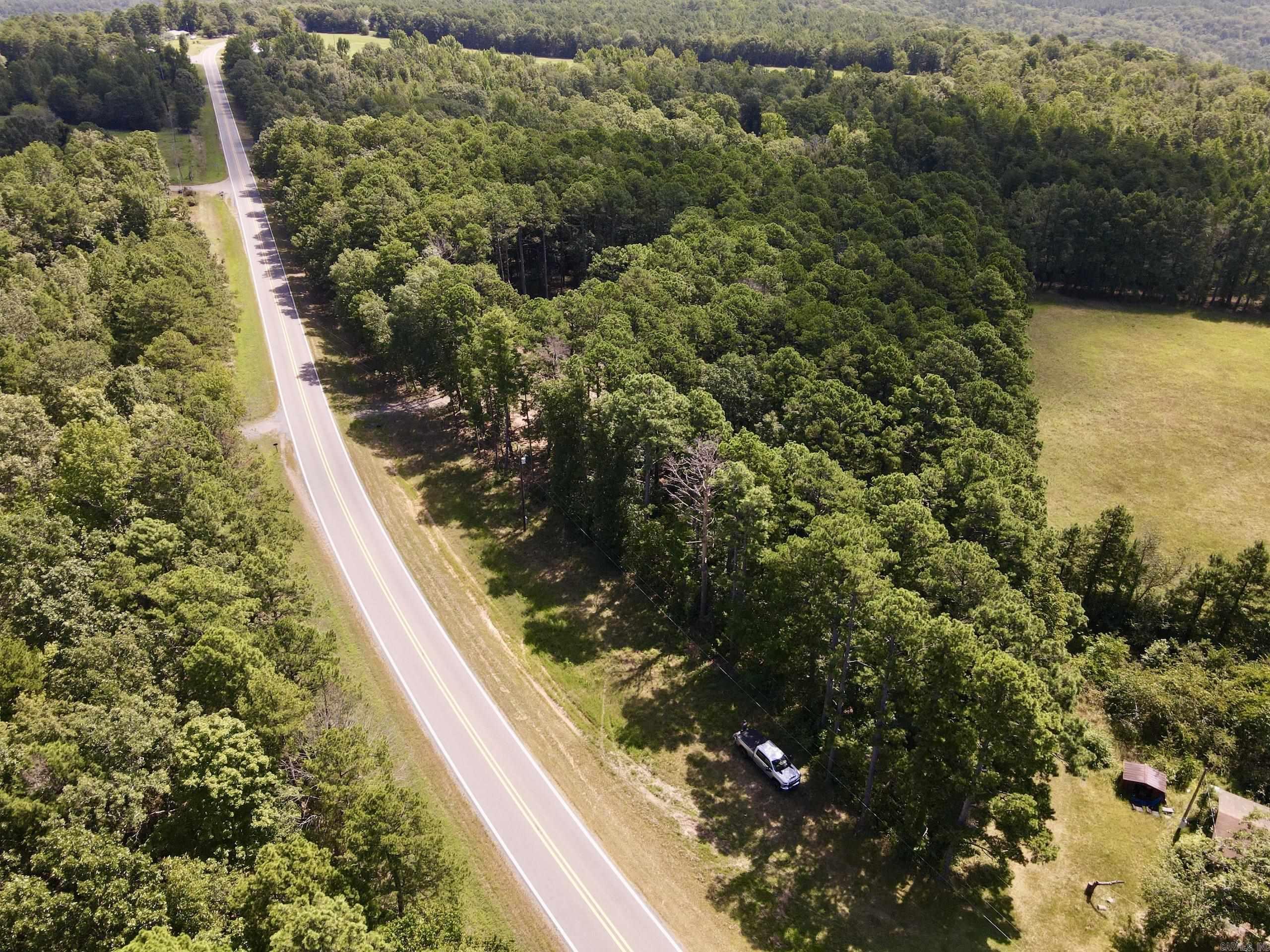 If youāre searching for unrestricted land for sale in Arkansas with utilities in place and prime highway frontage, this one checks every box. Situated along a state highway with approximately 825 feet of road frontage, this build-ready parcel offers convenience, natural beauty, and long-term potential. The gently sloping terrain is graced with tall pines for privacy, while the center of the property is already cleared and leveled - perfect for your dream home, cabin, or weekend retreat.