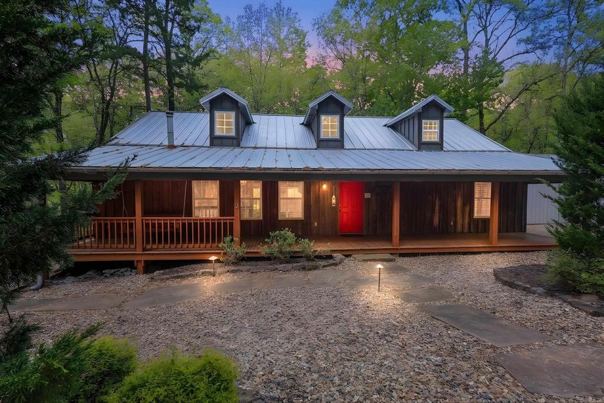 Versatile property designed to accommodate up to 16 guests, located just minutes from Lake Ouachita. The main home offers approximately 2,024 sq ft with 2 bedrooms, a lot that sleeps 4, and 2 bathrooms, featuring vaulted ceilings, wood floors, a dry bar, and a well-equipped kitchen with stainless steel appliances, granite countertops, and a warming drawer. Enjoy a screened porch, outdoor fireplace, and landscaped front entry with a concrete drive and water feature.  A separate 1,003 sq ft casita provides additional space for guests, bringing the total sleeping capacity to 16.  The property also includes a 1,068 sq ft heated and cooled 3-car garage with an additional washer and dryer hookup, plus a 450 sq ft foam-insulated, climate-controlled single garage—ideal for storage, hobbies, or lake gear. Generator-ready electrical is in place (generator not included).  Conveniently located approximately 4 miles from Mountain Harbor, 4.9 miles from Crystal Springs Recreation Area, and 22 miles to Hot Springs. Property is subject to some restrictions.