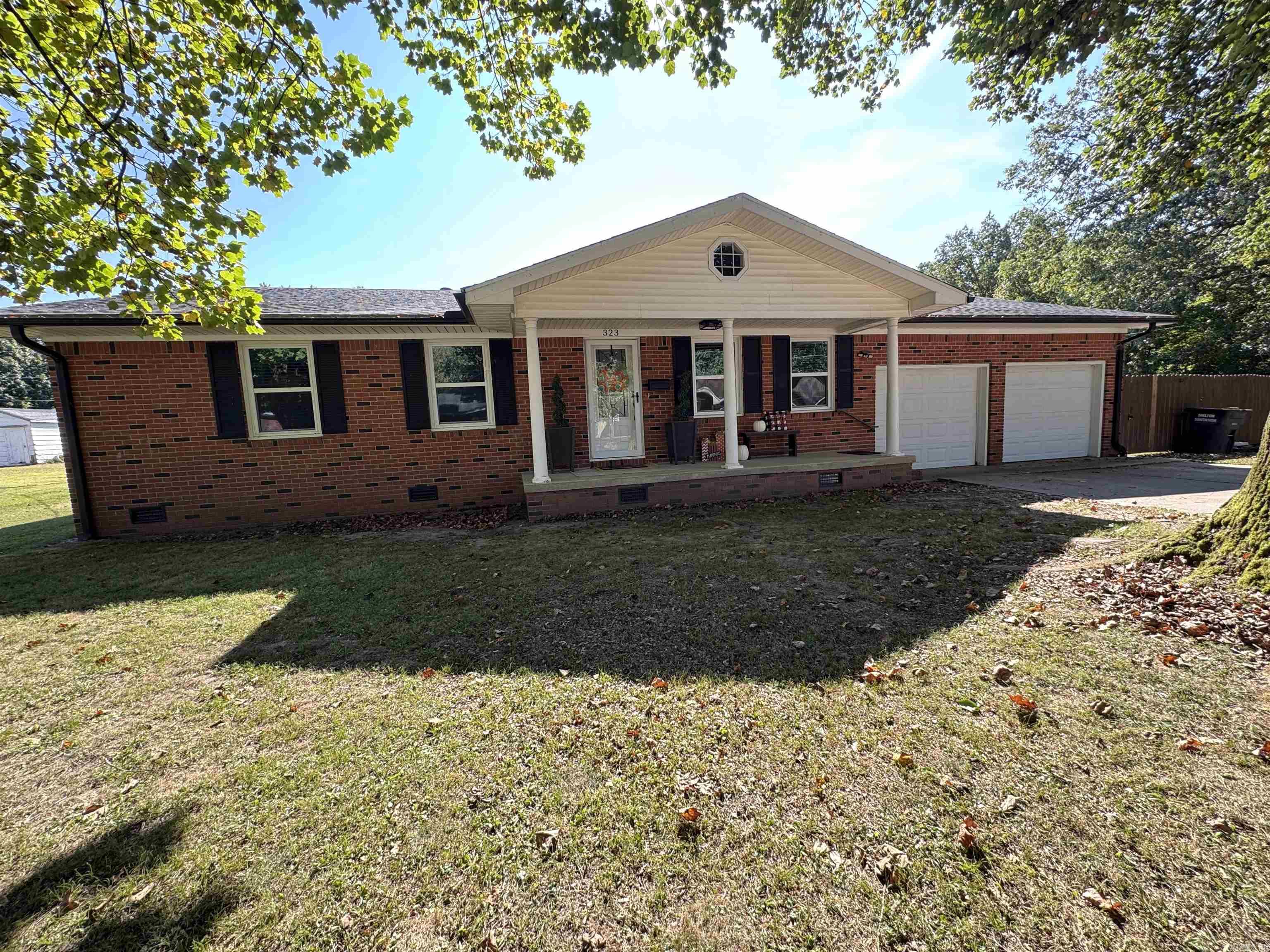 Welcome to 323 Lamb Drive in Piggott, AR! This well-appointed 3 Bedroom, 1.5 Bathroom, single story brick home offers approximately 2,015 sq ft of open concept living space. This charming home is perfectly situated on a .32-acre lot, fully fenced back yard with a 27 ft above-ground swimming pool perfect for outdoor relaxation and entertaining. The roof and gutters were replaced in 2021, ensuring recent structural updates for added peace of mind. The spacious two-car attached garage is great for vehicles, storage, or a workspace area. inside, the living room is adorned with a corner-stone gas fireplace, creating a warm and inviting focal point. The kitchen has been updated with new cabinetry and is equipped with stainless steel appliances. The three comfortable bedrooms offer ample space for families, guests or a home office. Fully remodeled bathrooms give a fresh, updated feel, and a functional laundry/mud room is accessible directly from the garage to keep entryways clutter-free. Whether you're looking for your first home or a place to raise a family, this property offers excellent potential in a desirable location. This move-in ready home is a must see!