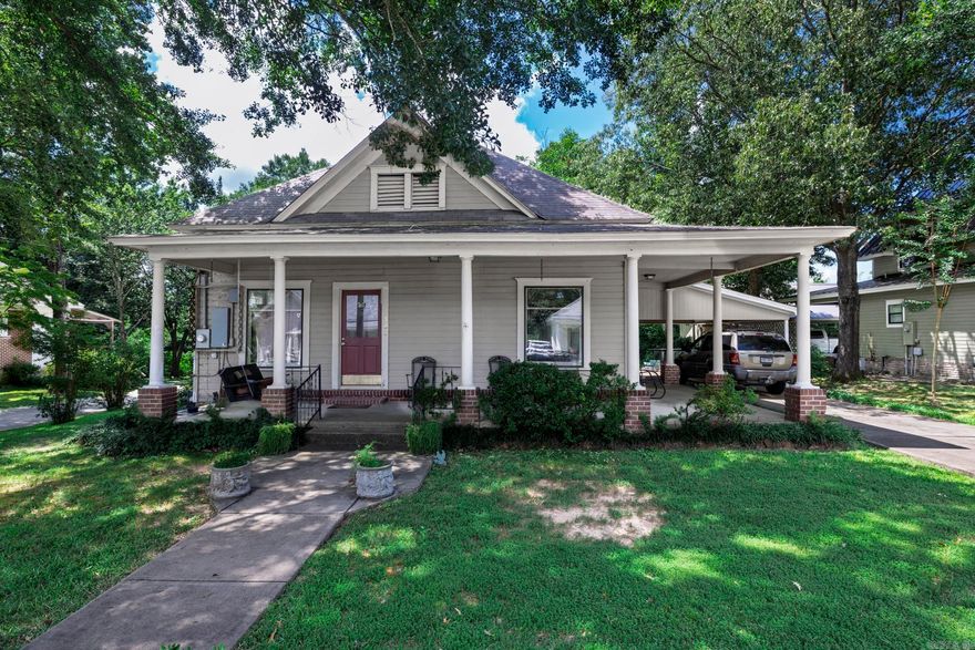 This beautifully maintained three-bedroom, one and a half-bath home is filled with charm and character, ideally located near Ouachita Baptist University. From the moment you arrive, you'll be greeted by a spacious and inviting front porch—perfect for morning coffee or unwinding in the evenings. Inside, the home showcases stunning historic details including tall ceilings, wide trim, solid wood doors, and original hardwood flooring that flows throughout the living spaces. Large windows invite an abundance of natural light, creating an open and airy feel in each room. The updated kitchen combines classic style with modern functionality, offering ample cabinet space and updated finishes. Each bathroom has been tastefully refreshed, featuring vintage-inspired touches that maintain the home's timeless appeal. With its prime location and elegant blend of old and new, this home offers both comfort and character in one of the most sought-after areas in town.