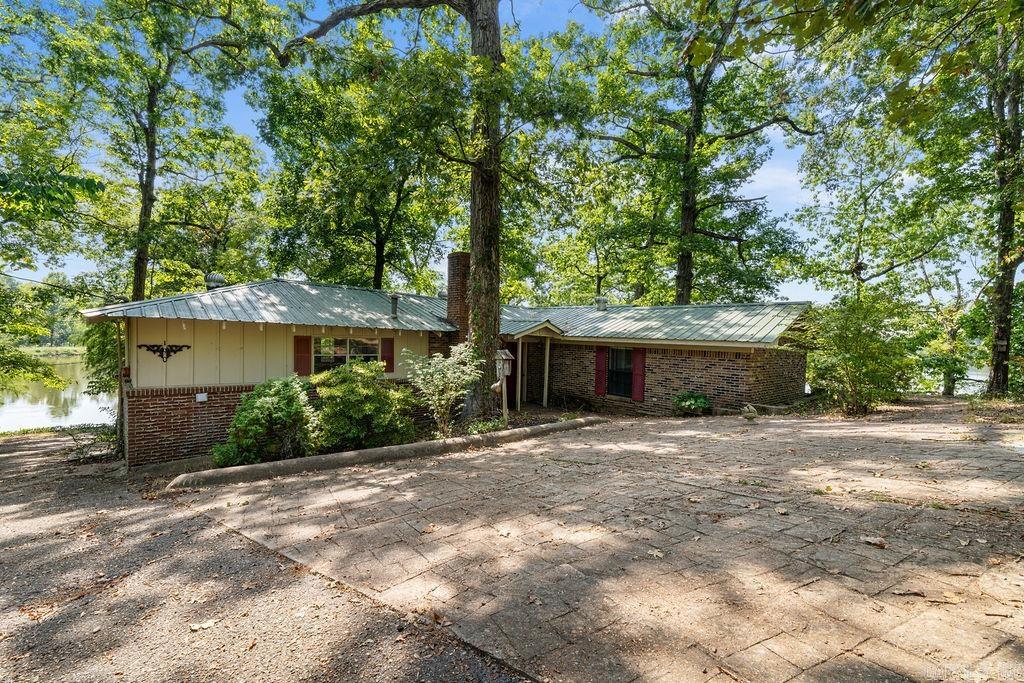 Enjoy lakefront living with this rustic 2-bedroom, 2-bath home on a private lake. Set on .88 acres, the home features a wraparound deck, cozy fireplace, and a detached shop with electricity for storage or projects. In addition to your own waterfront, this property includes a membership to Hunters Rest, providing access to 80 acres of hunting land and a 40-acre fishing lake. Whether you’re looking for a peaceful retreat, outdoor recreation, or a full-time home, this unique property offers it all.