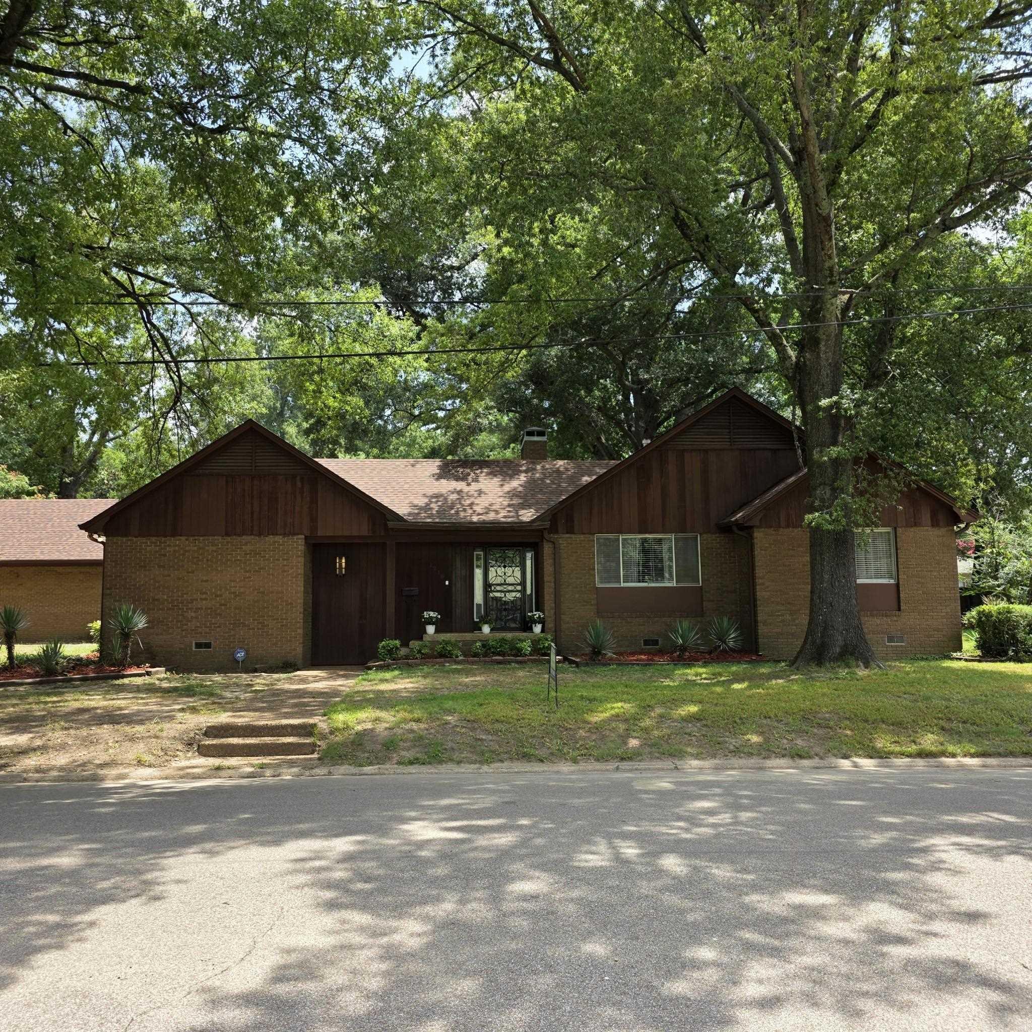 This charming older residence is situated on a spacious, oak tree shaded corner lot in the heart of town, offering convenient access to all amenities. The luxurious marble entryway leads to an expansive, formal living area featuring plush carpeting. A formal dining room and sizable den with a fireplace are additional highlights. The bonus room, located upstairs, could potentially serve as a fourth bedroom. The fully fenced backyard boasts a large, covered patio ideal for outdoor entertainment.