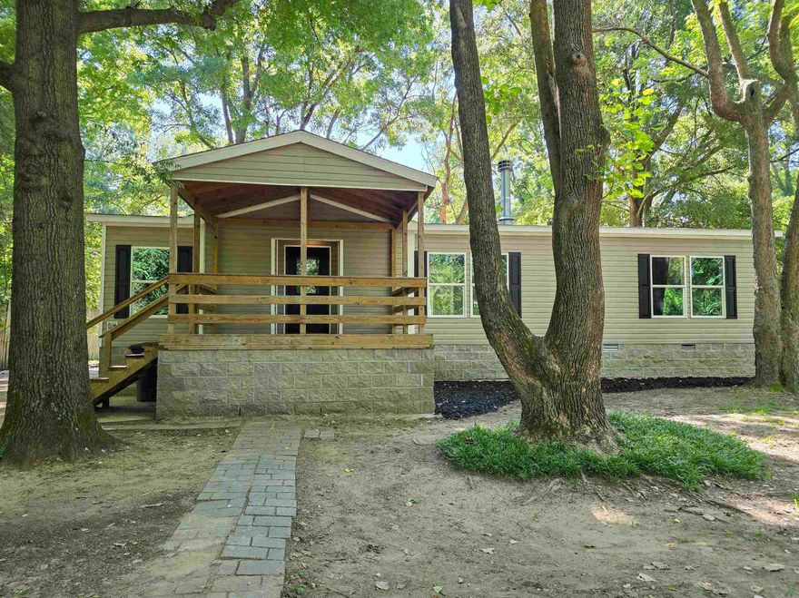 What a fabulous 3 bedroom & 2 bath home that has gone through a complete remodel & refresh! The owners of this modular home across the street from Little River chute went in and just revamped this into a bright, airy & gorgeous home. Covered front deck/porch enters into the living room with fireplace but what you see is beautiful laminate flooring through to the combo dining/kitchen. What you notice is the natural light from the large windows. The kitchen features an island with breakfast bar, stainless 1-bowl sink and butcher-block countertop. This same countertop is used on the rest of the kitchen counters. Kitchen is outfitted with a freestanding gas range with integrated griddle, microwave/vent hood, stainless dishwasher and Samsung refrigerator. This home has a split bedroom plan with the 2 secondary bedrooms that both have walk-in closets and with the spacious Primary bedroom that has large walk-in closet, and a spectacular en-suite bath that is like a spa as it includes a large soaker tub, oversized custom ceramic tile shower with bench and an expansive, dual sink vanity plus make-up area. Simply an amazing home on a tree shaded lot.