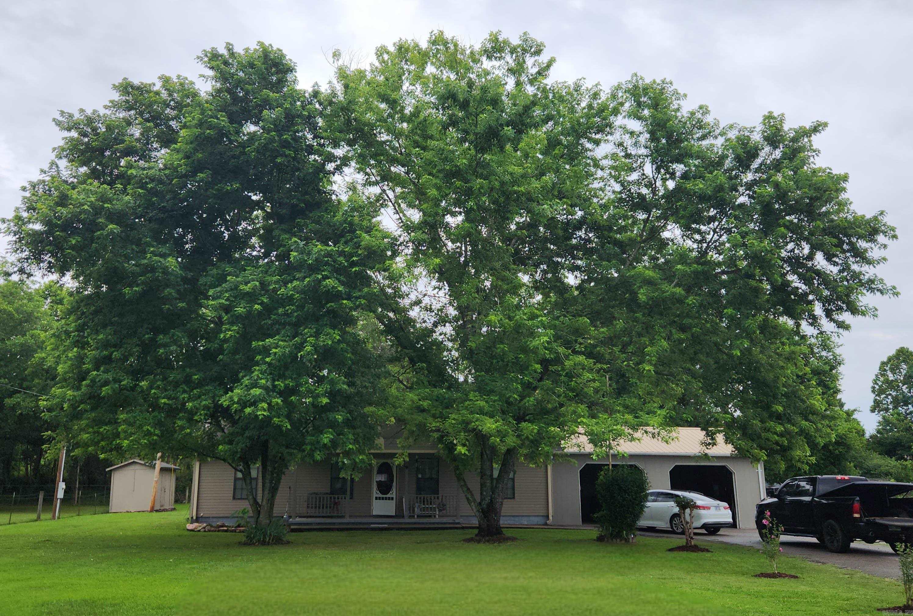 Nice flat yard, shade trees, 2 car garage, shop, fenced yard & gated drive.