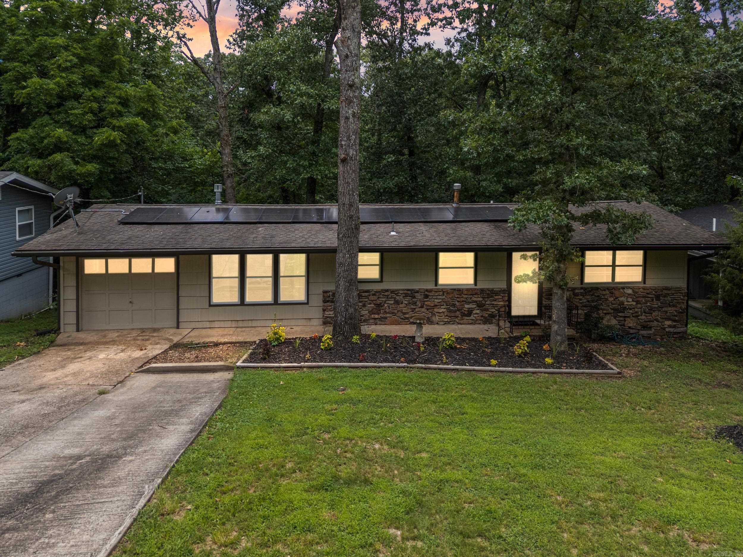 Welcome Home! Ideally located near Tanyard Creek Driving Range, Tanyard Creek Trail, Lake Windsor, Lake Avalon, The Bella Vista Country Club, Biking Trails, shopping and restaurants, this updated home offers both comfort and convenience. Fantastic for a first time homebuyer, someone looking to downsize, or someone looking for a VRBO/Rental! Step inside to discover a modern kitchen featuring brand-new appliances, granite countertops, a walk-in pantry, and a built-in dining bench—perfect for casual meals or entertaining. New flooring flows throughout the home, leading to a spacious living area complete with custom built-ins and plenty of room for family game nights or movie marathons. The layout includes a secondary bedroom with a dedicated full bath, as well as a primary suite with its own private en suite bathroom. Relax on your back deck and take in the peaceful natural surroundings—an ideal spot to unwind. Additional updates include a new water heater, a brand-new dual heat pump HVAC system, and energy-saving solar panels. Don’t miss your chance—schedule a private showing today!