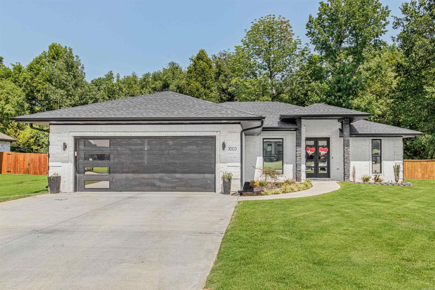 Welcome to your dream home! Step into this stunning custom built white brick residence, elegantly adorned with sleek black accents. Built in 2021, this modern abode boasts four spacious bedrooms and two large bathrooms. The 9, 10, and 11-foot ceilings create an airy and grand ambiance throughout. The open floor plan effortlessly combines style and functionality, perfect for both entertaining and relaxation.   Storage enthusiasts will rejoice at the presence of several storage closets, ensuring ample space for all your belongings. Park your car with ease in the oversized garage. A fenced backyard and generous lot size offer privacy and endless possibilities for outdoor activities. Unwind on the delightful covered back porch, complete with a large additional patio area for hosting gatherings or simply savoring peaceful moments.  *THIS PROPERTY IS OWNED BY A LICENSED REAL ESTATE AGENT*