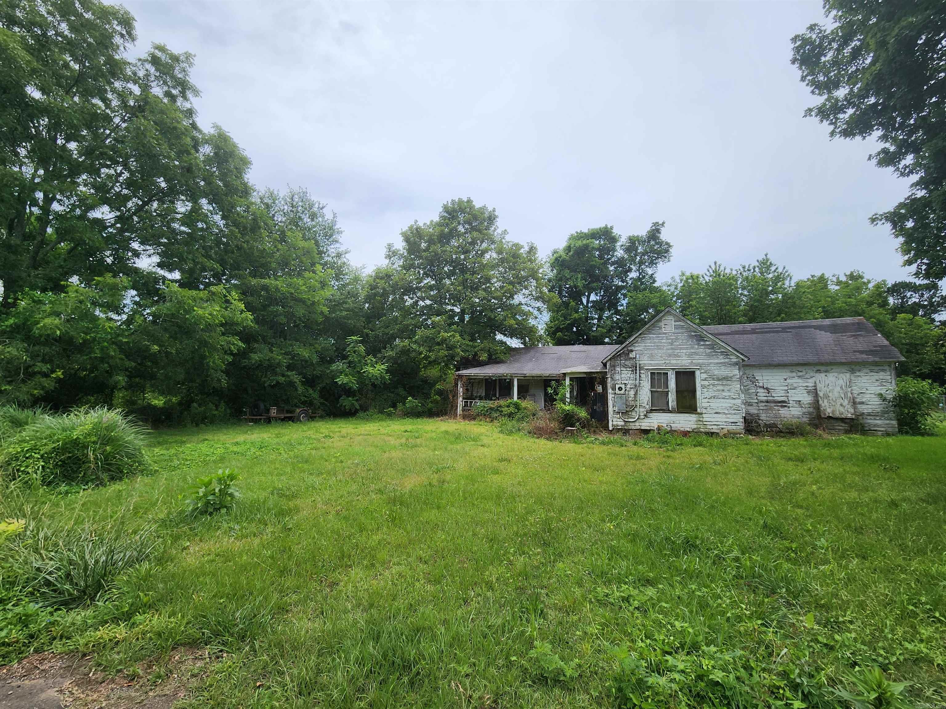 Rare opportunity to own a sizable piece of land within the city limits of Mena, AR! This spacious lot offers ample room to build your dream home or pursue a development project in a quiet, convenient location a short distance from downtown Mena. Whether you're a builder, investor, or future homeowner, this parcel provides flexibility and potential. PLEASE DO NOT ENTER OLD HOME, AGENT MUST BE PRESENT.