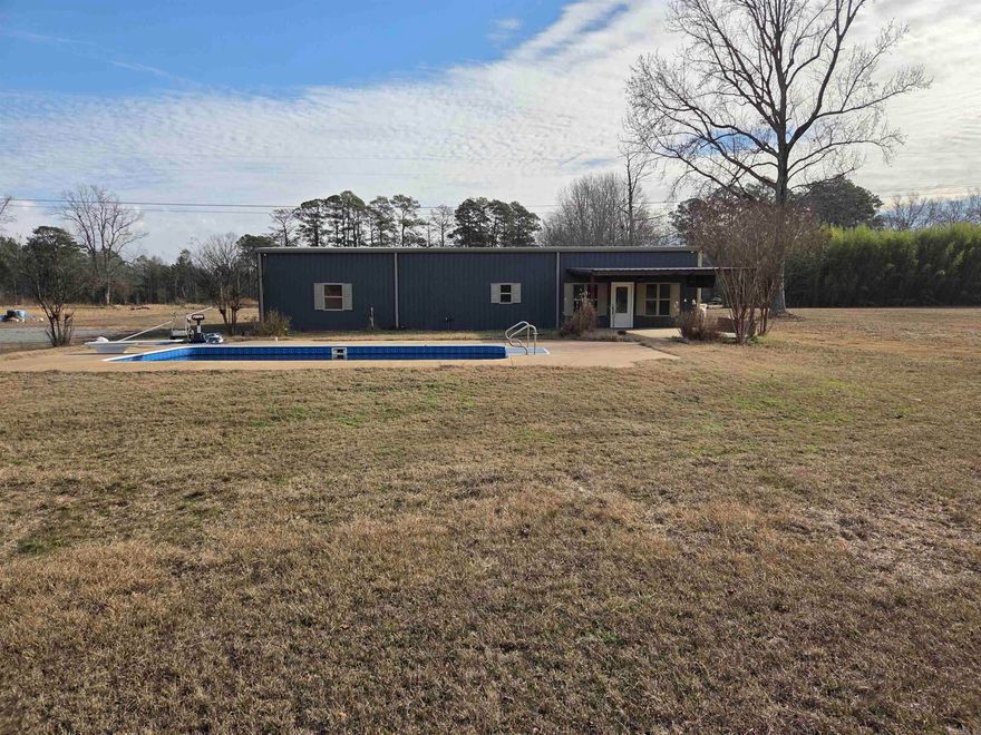 Tucked away at the end of a long, scenic drive, this 16.1-acre property offers privacy, space, and room to dream. The main home features two bedrooms with abundant additional space that can easily be converted into extra bedrooms, living areas, or creative workspaces to fit your vision.  Out front, enjoy a refreshing pool that sets the tone for relaxed country living, while the back of the property opens up to a peaceful pond—perfect for unwinding, wildlife watching, or creating your own backyard escape. Multiple buildings on the property add flexibility for storage, workshops, guest space, or future expansion.  Whether you’re looking to create a personal retreat, hobby farm, multi-use property, or simply a place with room to grow, this land offers a rare combination of natural beauty, privacy, and opportunity. A true hidden oasis with endless possibilities.