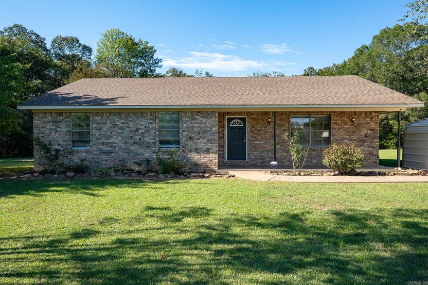 This precious move-in ready 3-bedroom, 2-bath home offers nearly 1,500 sq. ft. of comfortable living space on a private, approximately one acre lot at the back of a quiet loop drive. Inside, you’ll love the fresh new carpet, new paint, new light fixtures, new blinds and bright living area that flows into a charming kitchen featuring stainless steel appliances and a new dishwasher. The dining area is a great size with beautiful new glass sliding doors that access the backyard. The primary suite includes its own ensuite bath, while two additional bedrooms share a nice hall bath. Outside, enjoy plenty of room to spread out with a great yard, a pretty rock lined flowerbed out front, two storage buildings, a large covered carport, and peaceful surroundings that provide both privacy and convenience.