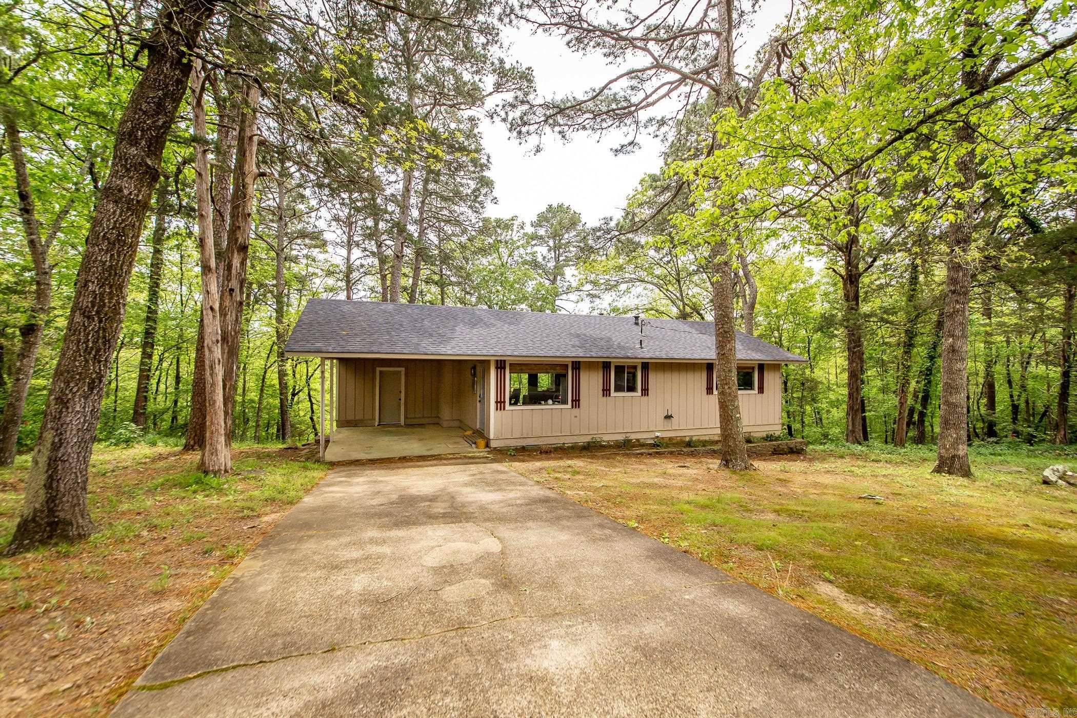 Welcome to your weekend retreat! This charming home has been recently updated with a new roof, HVAC, light fixtures, & interior paint. Fairfield Bay Marina is 5 min. away. Nice vaulted ceiling with wood beam in the living room. Open living/kitchen area. Covered back deck to enjoy tranquility & serene outdoor nature. Work shop area in the lower level. perfect space to unleash your creativity and bring your ideas to life. It's an ideal setup for those who enjoy hands-on activities or need a dedicated space for hobbies. Take advantage of the path that leads to the lake to go kayaking. Access to Bay Amenities: Embrace the convenient lifestyle offered by this home's proximity to the amenities of the bay. Indulge in the nearby recreational facilities, including golf courses, tennis courts, pickle ball courts, hiking trails, and more. This location ensures there's never a dull moment, catering to your desire for both relaxation and adventure. New windows in the crawl space that were never installed will convey.