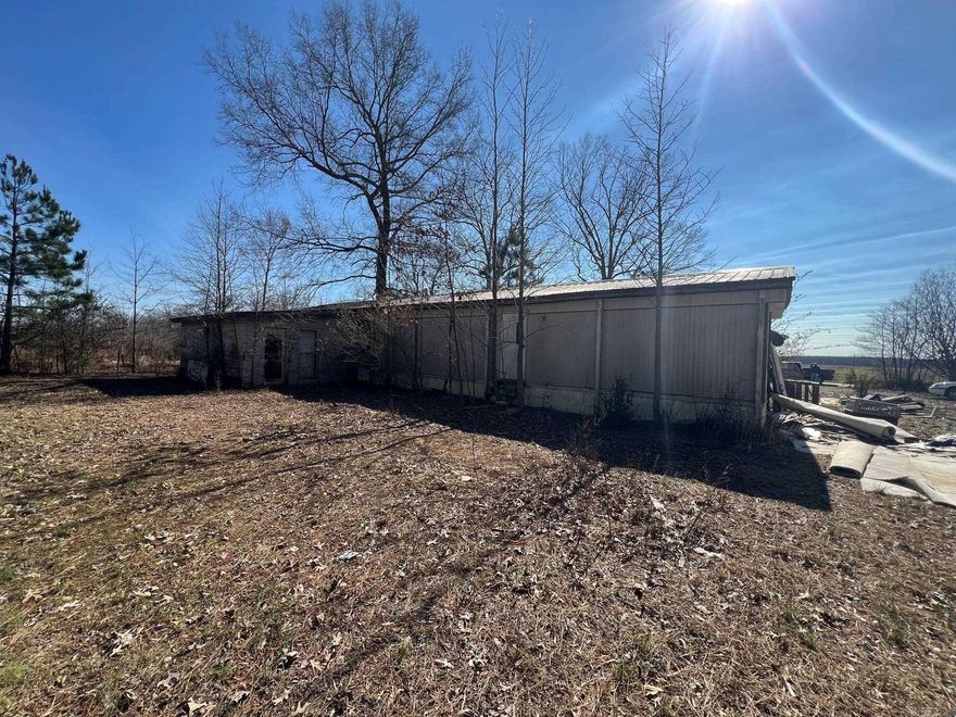 Fixer upper Mobile Home on one acre of land Has a room addition on the back.  Needs lots of work but has potential owner will finance this property