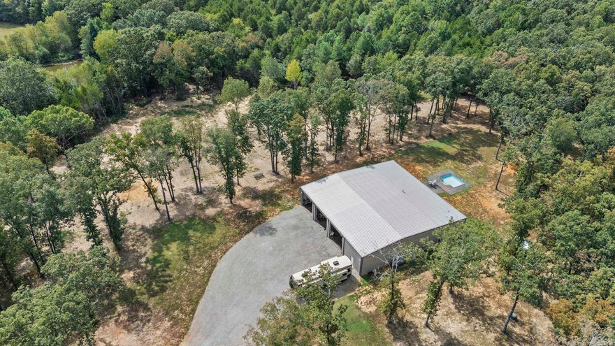 Work here, play here, live here! This one-of-a-kind barndominium sits on 12.77 acres just minutes from the city limits of Searcy offering approximately 1920 sq ft of H/C living space, 4800 sq ft of insulated H/C shop space.This red-iron building perfectly blends, comfort and function. Inside its all about the details-crown molding, custom cabinetry, wall ovens built-in grill,  spa-style shower. Outdoors, you'll find an in-ground pool, fenced yard and an 8 x 12 storage building with electric. Perfect for downsizing or retirement living, with space to expand if desired. Private and peaceful setting close to everything.