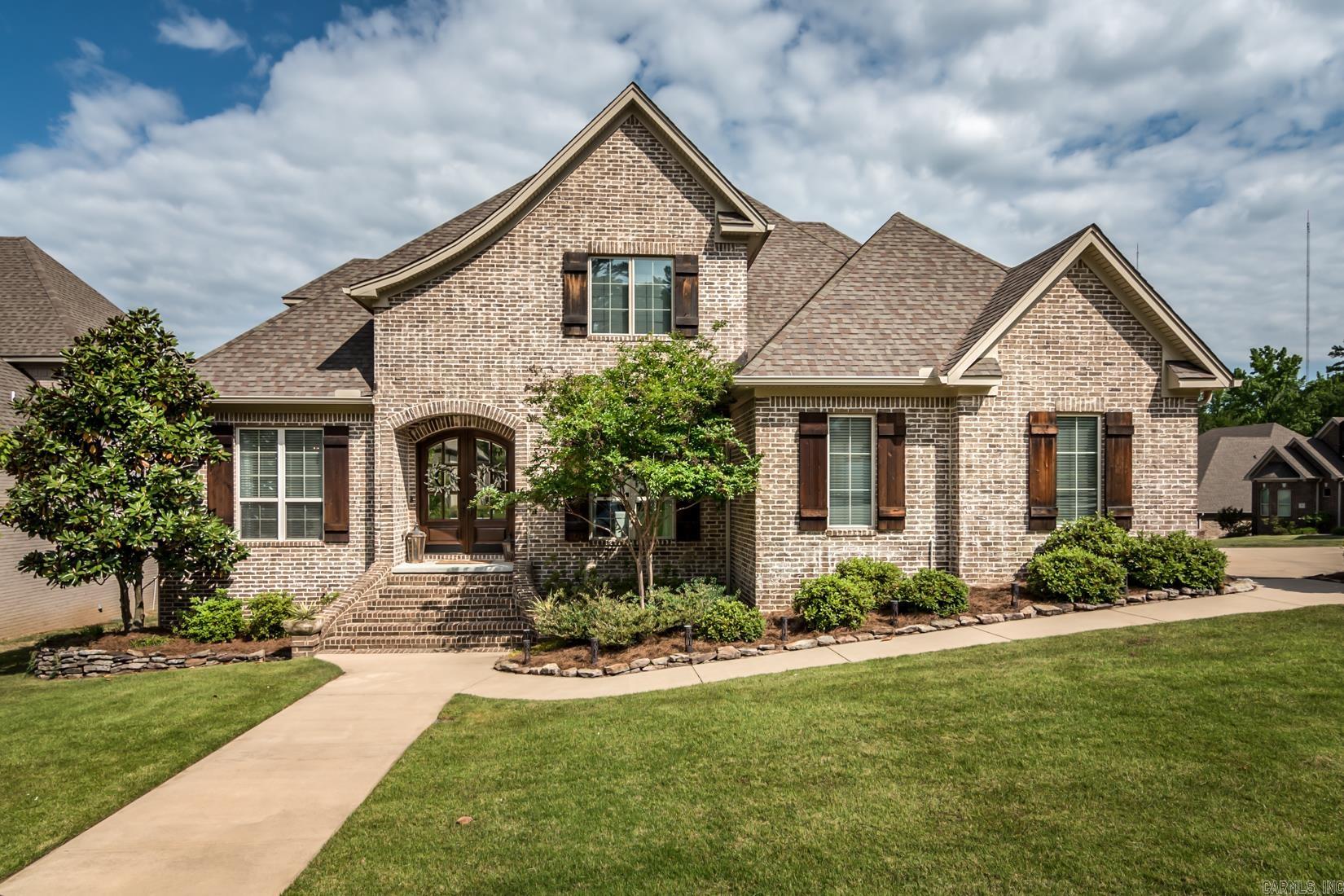 Exceptional Chenal Valley home with timeless design positioned on a corner lot adjacent to golf cart paths to the golf course. Welcome home through double arched wooden doors greeted by an open-concept floor plan, with a formal dining room ideal for hosting gatherings.The heart of the home resides in the great room and gourmet kitchen, exuding a cozy atmosphere.The great room features a fireplace with oversized windows frame the picturesque views of the screened-in porch. The kitchen features Quartzite countertops and Thermador appliances, including a gas range, a KitchenAid ice machine, a Sharp microwave drawer and spacious walk-in pantry. Tucked away for privacy, the primary bedroom suites offers a spa-like bathroom with architectural elegance, featuring a soak tub, shower and his & her bathroom vanities. The primary closet boasts spacious storage & a second laundry service.Two additional guest bedrooms, with en-suite bathrooms, are on the main level.Throughout the main living areas and bedrooms, oak hardwood floors imbue the space with character.Upstairs features a spacious game room, two bedrooms and a hall bathroom. **Previous buyers changed their mind without inspecting!