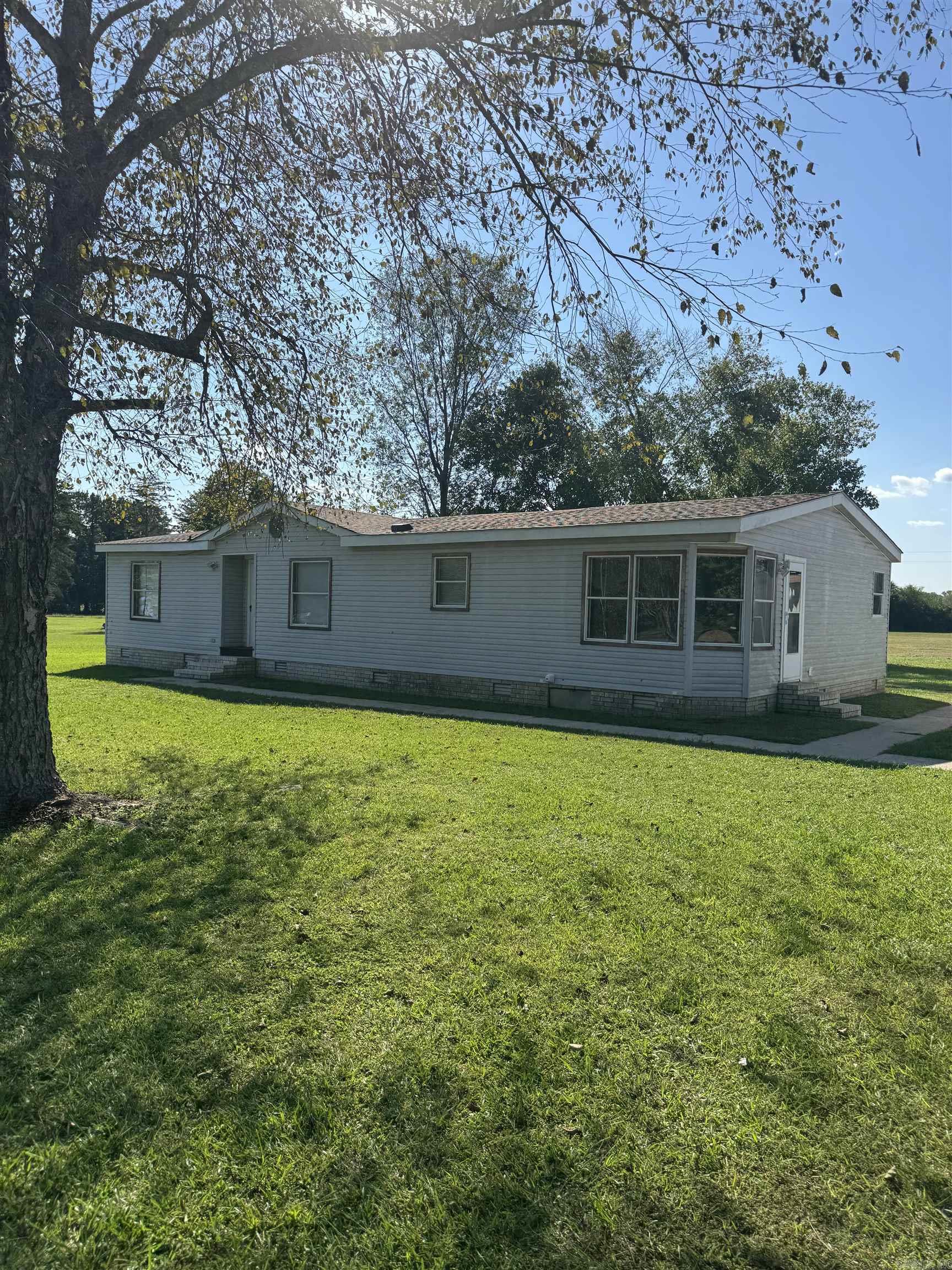 3/2 bath double wide home on permanent foundation that sets on 3.06 beautiful acres m/l. 21 x 27 shop with electric and garage door opener. Additional shed with lean-to would make a great storage building for implements or animals. This home has had a new roof installed 2 years ago both on house and shop. New HVAC unit was installed 2 years ago also. Many upgrades in home includes newer appliances, new shower installed and rooms painted about 2 years. The home is surrounded by concrete walkways that lead to a porch that was installed around 2022. Don't wait this one will not last long. House is being sold AS IS. Agent see remarks