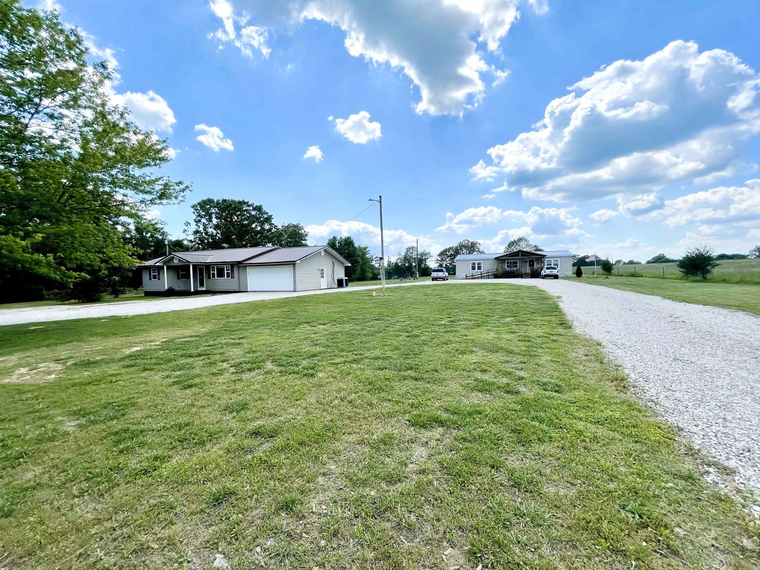 RARE FIND – Two Beautiful Homes on 1.83 Acres! Discover a unique opportunity with this 3-bedroom, 2-bathroom property, double-wide manufactured home(3 Bed 2 Bath) and a 1232 sq. ft. traditional home (3 Bed 2 Bath) with separate addresses and meters, offering incredible flexibility for multi-generational living or investment potential! County water plus a private well for added convenience Wheelchair ramps for easy entry Central heat and air, custom built fireplace, and a new large covered deck for relaxation Walk-in closets, pantry with pull-out shelves, and stainless steel appliances Step-in shower, jacuzzi tub, and double sinks for a touch of luxury A level yard, fencing for privacy, two sheds, and a garage Just 1 mile from the state highway, ensuring easy access This clean, well-maintained property is move-in ready and packed with features that make everyday living comfortable and convenient. Don’t miss this opportunity! Call today to schedule a showing!