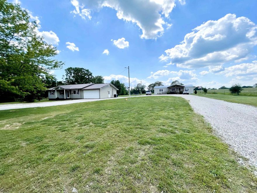 RARE FIND – TWO BEAUTIFUL HOMES FOR THE PRICE OF ONE! 1.83 ACRES WITH BOTH HOMES FOR $230,000  Discover a unique opportunity with this 3-bedroom, 2-bathroom property,  double-wide manufactured home(3 Bed 2 Bath) and a 1232 sq. ft.  traditional  home (3 Bed 2 Bath) with separate addresses and meters, offering incredible flexibility for multi-generational living or investment potential!  County water plus a private well for added convenience   Wheelchair ramps for easy entry  Central heat and air, custom built fireplace, and a new large covered deck for relaxation  Walk-in closets, pantry with pull-out shelves, and stainless steel appliances  Step-in shower, jacuzzi tub, and double sinks for a touch of luxury   A level yard, fencing for privacy, two sheds, and a garage  Just 1 mile from the state highway, ensuring easy access  This clean, well-maintained property is move-in ready and packed with features that make everyday living comfortable and convenient.  Don’t miss this opportunity! Call today to schedule a showing!