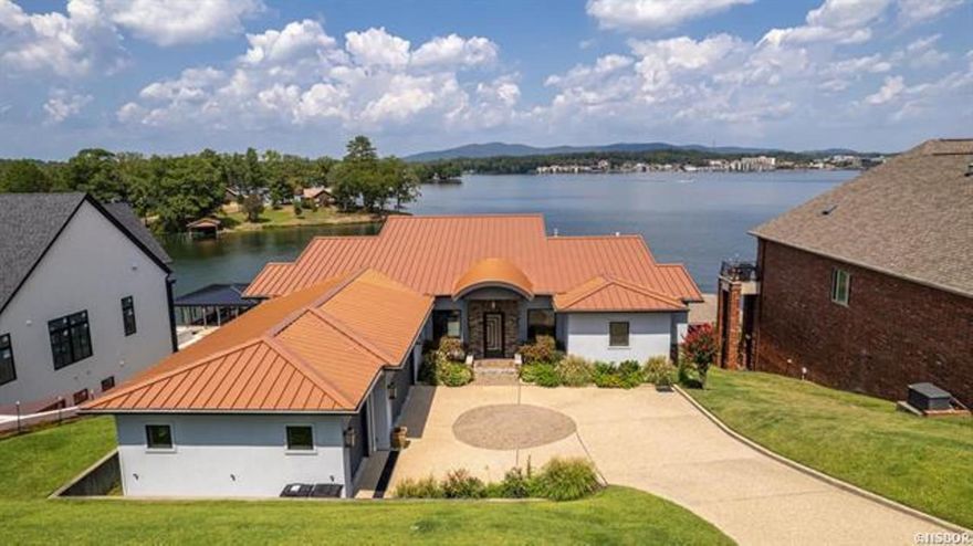 No detail left out! This gorgeous lakefront home has absolutely everything you could ever dream of and more. Million dollar views, outside living areas complete with a kitchen and fireplace perfect for bringing the party outside. The master en' suite has the feeling of a luxury hotel with all the upgrades. The open floor plan and space for a large family and entertaining. Elevator, generator and plenty of additional storage in the basement. This one has it all and so can you!