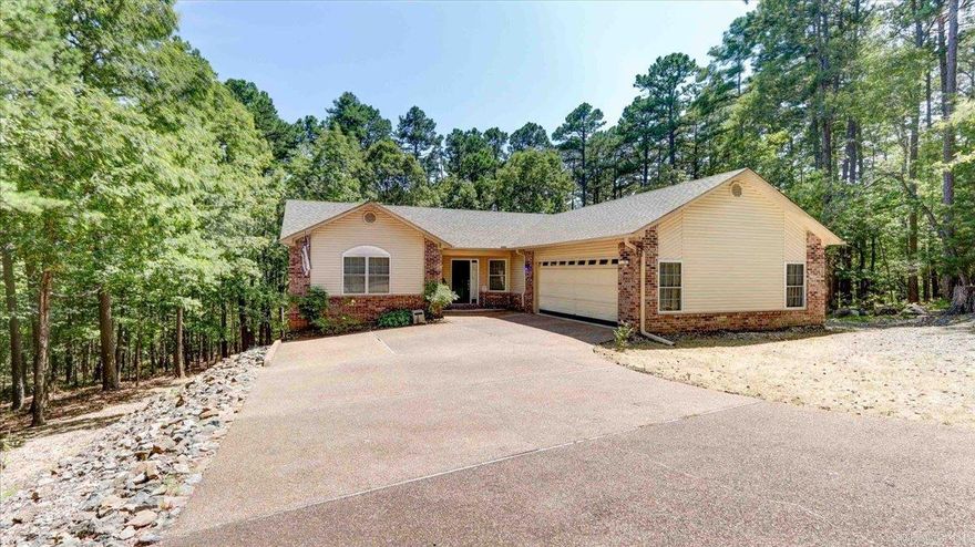 Discover your private sanctuary in Hot Springs Village! This inviting 3-bedroom, 2-bathroom home offers 1,650 sq ft of comfortable living space, nestled on a peaceful cul-de-sac. Surrounded by woods, the home provides plenty of privacy. The living and dining area features a cozy gas log fireplace, perfect for gatherings or quiet evenings. Step outside onto the spacious partially covered deck that overlooks a partially fenced backyard, where you can enjoy serene views of the surrounding woods. Access the deck from the principal bedroom featuring bath with step-in shower, while two additional bedrooms apart provide flexibility for guests or a home office. The roof, gutters and gutter guards were replaced in May 2024, HVAC replaced 2023, entire interior repainted in 2021.  This home combines comfort, privacy, and the natural beauty of Hot Springs Village, making it an ideal place to call your own.