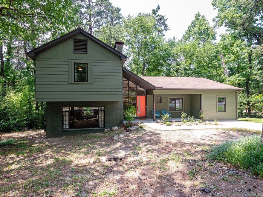 Nature abounds with this remodeled Mid-Century Modern 3BR/2BA home spanning 2,061 sf. The home sits on almost half an acre of mature pines & oaks, across the street from thousands of acres of undeveloped National Park land. Professionally painted inside & out with high-quality Sherwin-Williams, less than 1 yr. This home boasts new fixtures, fans & plenty of natural light. Remodeled kitchen features stainless-steel appliances less than 2 y.o., induction range w/air-fry oven, LG French door frig, dishwasher, microwave & leathered granite countertops. A spectacular outdoor dining deck off the kitchen, an eat-in kitchen plus separate dining room for families & entertaining. This tri-level home offers a spacious den w/wood burning fireplace, perfect for cozy evenings. Upstairs 2BR/1BA w/outside deck includes a premium hot-tub (4 yr wnty left) and in-closet attic access for added convenience. Lowest level displays laundry room with washer/dryer + walk-out bonus room. Live in a quiet, historic neighborhood a short 15 minute walk from restaurants, shopping and Bathhouse Row. Don’t miss this opportunity to live on North Mtn where nature is your neighbor. Schedule your private showing today!