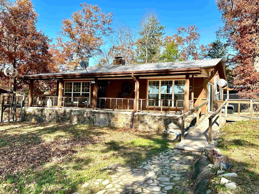 Listen to the sounds of the year-round creek as you relax on your back deck! This home sits on 6.5 acres located in Melbourne right on Mill Creek. You can fish for small mouth bass & kayak right from your back yard!  The main level of this home features a large living area with native stone fireplace, spacious kitchen, sunroom, master Bedroom with full bathroom & a guest bedroom. The walk out basement features additional living space, storage area, safe room, bedroom, full bathroom, & laundry room. Outside the home is a 2 vehicle carport, 32x48 shop, 2 storage sheds, green house, gardening area, & full RV Hookup! Additional land can be purchased! Seller is offering a $10K credit with an acceptable offer for any repairs needed!