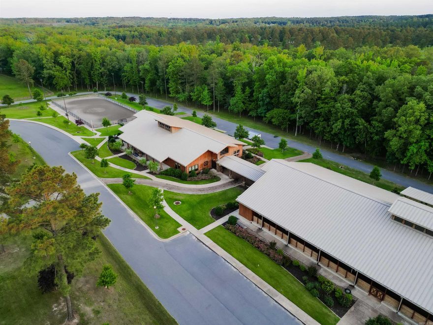Welcome to The Pine Hill Ranch—an extraordinary 200-acre equestrian estate in West Little Rock, offering a rare blend of world-class horse facilities and refined Southern charm. The centerpiece is a climate-controlled 12-stall barn with custom stalls, memory foam mats, rubber brick floors, and French drains, along with a private office suite, feed and tack rooms, oversized wash bay, laundry room, and an entertainment loft. Advanced features include indoor/outdoor AV, five large-screen TVs, a 36-camera security system, and a smart fly spray system. A breezeway leads to the 80x180 covered arena with fans, bleachers, announcer’s booth, AV room, and private bath. The estate also boasts nine fenced and water supplied pastures and over eight miles of manicured, creek-lined trails with culvert-protected bridges that are wide enough for emergency vehicles—ideal for riding, recreation, or future development. All tack and equipment convey, including Gators, a John Deere tractor, and zero-turn mowers, making this a truly turnkey operation. This isn’t just a property—it’s a legacy in the making. Please watch the video virtual tour to get the full scope of the beauty.