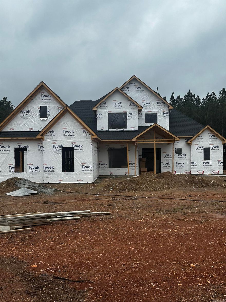 Set on over 8 acres, this stunning new construction home offers the perfect blend of luxury, privacy, and thoughtful design. With approximately 3,900 sqft, this home delivers exceptional space. Inside, you’ll find 5 bedrooms, 3.5 bathrooms, a dedicated office, with a large bonus room, including two en-suite bedrooms on first floor—perfect for guests or multigenerational living. The main living area features a cozy gas fireplace and opens seamlessly to the outdoor living space through a dramatic 12-foot sliding door, creating the perfect setting for entertaining.  The kitchen is designed for both function and style with a gas range, abundant storage, and a separate butler’s kitchen/pantry that makes hosting effortless.  The spacious primary suite is a space of its own, featuring a luxurious bath with a pass-through walk-in shower and freestanding soaking tub, custom storage, and thoughtful toe-kick lighting. With acreage, luxury finishes, and modern efficiency, this home offers a rare opportunity to enjoy space, comfort, and refined country living without sacrificing style or convenience. Minutes from the interstate and zoned for Benton Public Schools. Agents- See remarks