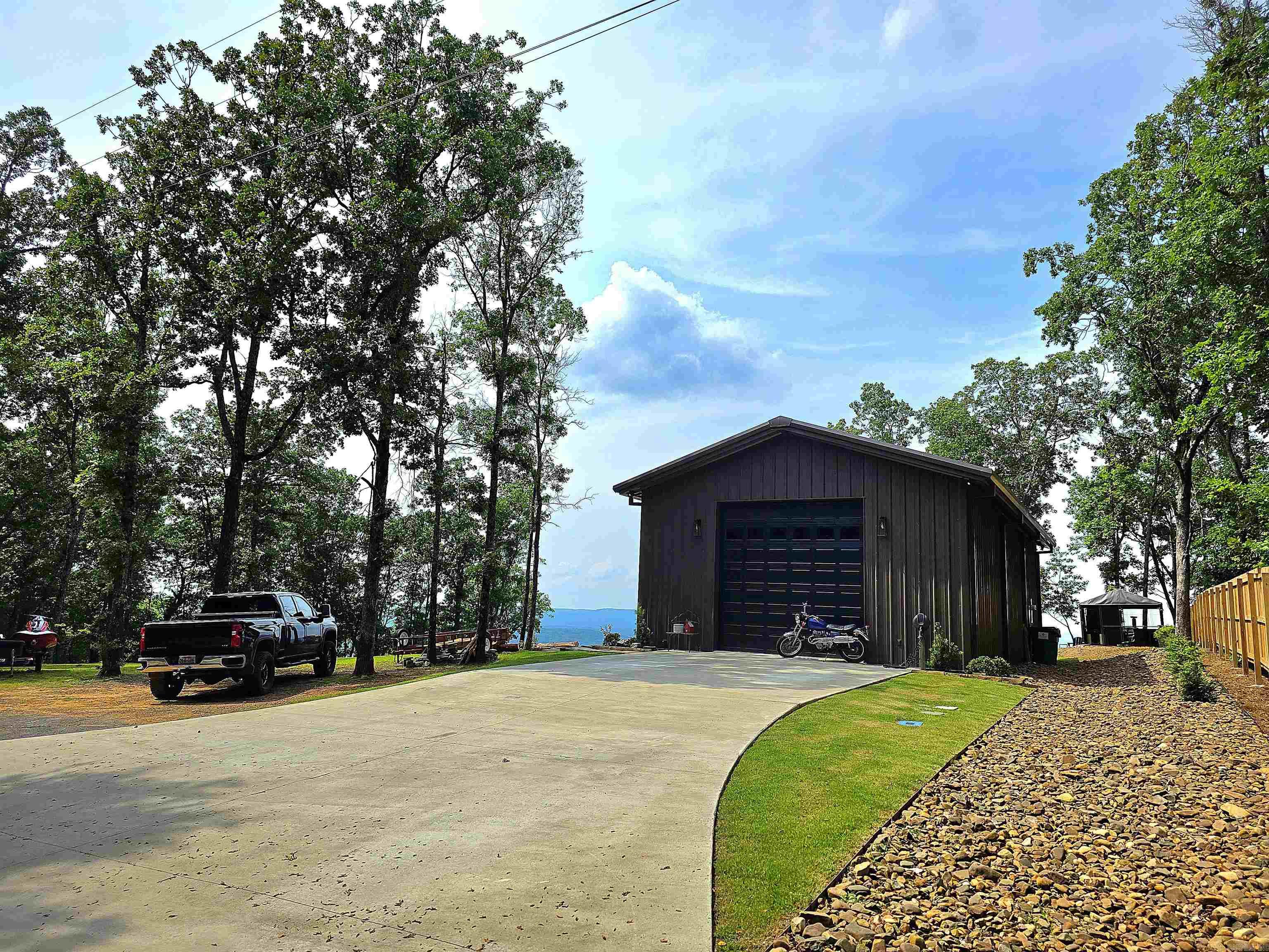Make it yours!!! The Diamond Bluff area has million-dollar views, but each view is unique in its own way! This custom-built property is ready to make your Greers Ferry Lake view living possible and with so many options available to make it your own. The entire building is heated and cooled with a total of 1586 sq/ft. The building is ready to be lived in now while you build your future home with a full kitchen, full bathroom, and washer and dryer on bottom floor and a bedroom loft directly above that will comfortably fit 2 queen beds which totals 676 sq/ft. The remaining 910 sq/ft clean slate open space could be used as a shop/boat storage or can be additional living/entertaining space which is what it is currently being used as. Square foot measuring encourage. Agents, please see all remarks.