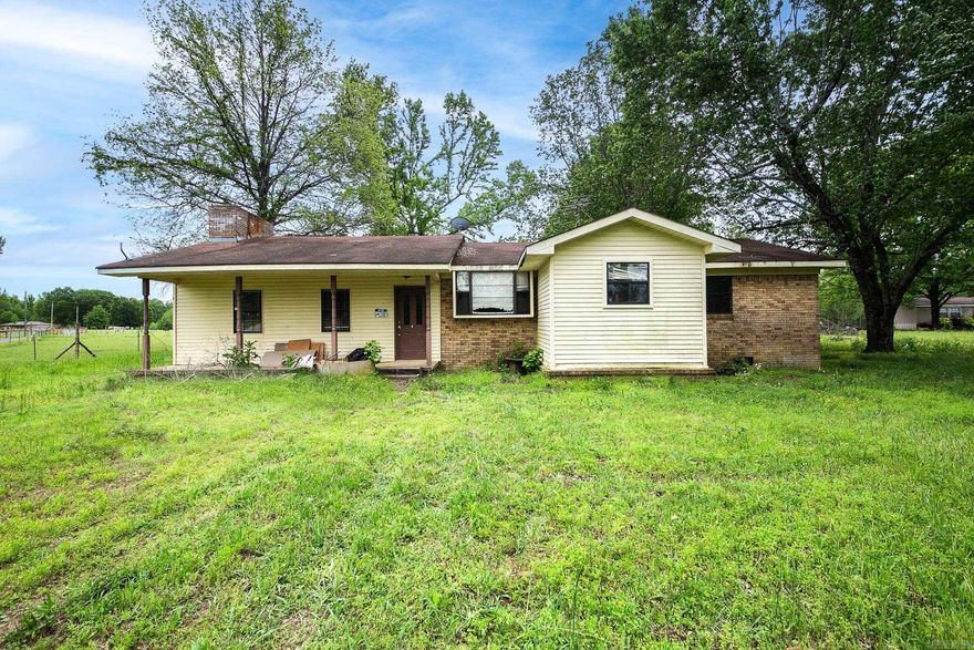 Nestled in a serene setting, this charming property presents a golden opportunity for investors with a vision. The heart of this residence is undoubtedly its expansive living space, anchored by a real wood-burning fireplace that promises warmth and ambiance during cooler evenings. Imagine the crackle of the fire as the focal point for gatherings or a peaceful night in. The kitchen and dining area extend an invitation for culinary exploration, offering ample space for meal preparation and entertaining. This area provides a blank canvas for upgrades or a modern makeover, allowing new owners to add their personal touch and increase the property's value. Outside, the property continues to impress with its detached carport, which holds the potential to be fully enclosed, offering additional secure parking or storage options. Even has a workshop! All of this is set on a 1acre lot, providing both privacy and space for outdoor activities. With a little bit of love and some creative vision, this home could easily become a cherished first home or a lucrative addition to a rental investment portfolio. AGENTS SEE REMARKS!! Property being sold as is.