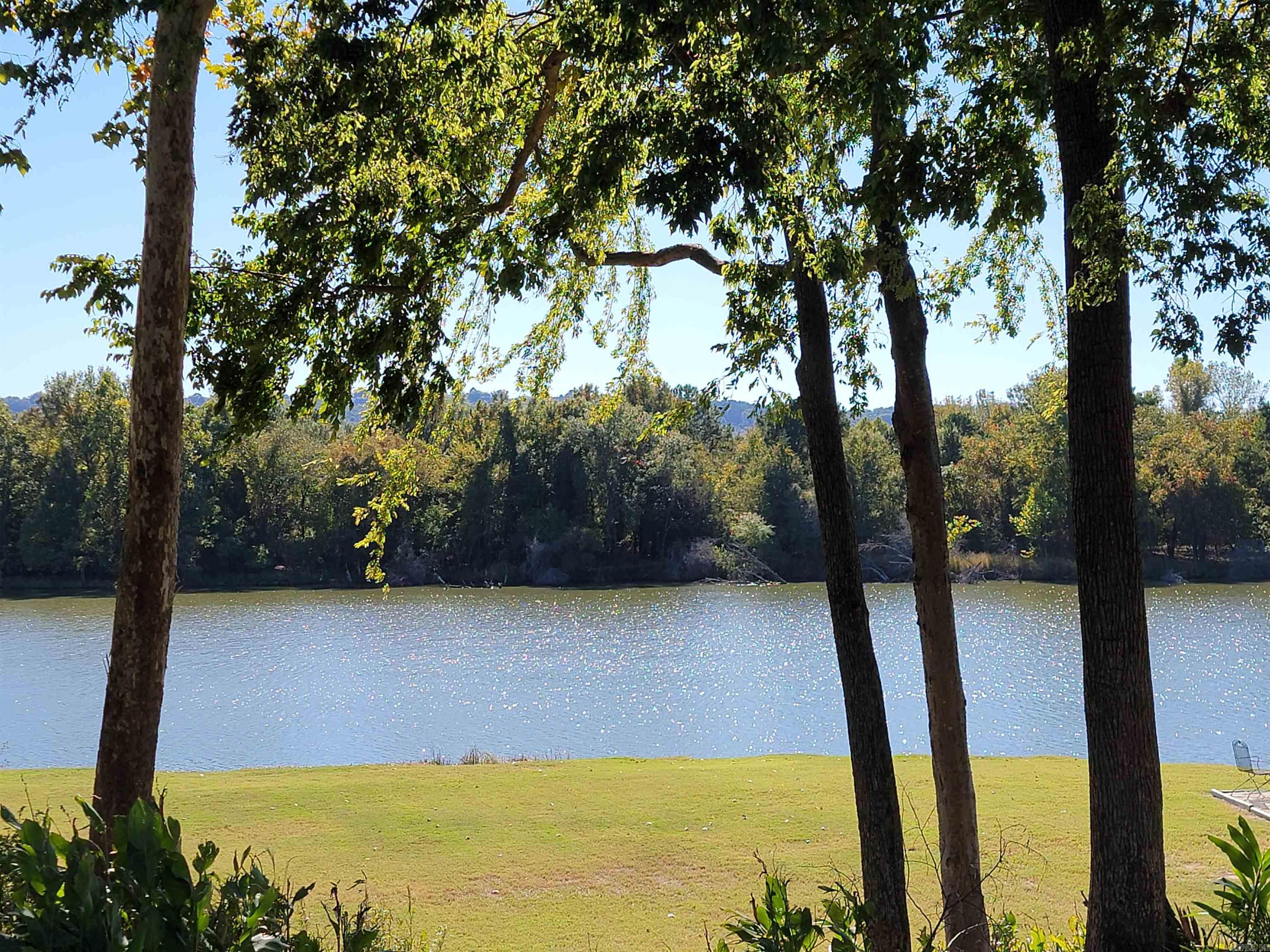 Beautiful level lot in a great area that is private and backs up to a green space and the Arkansas River. Build your dream home! Neighborhood (only) amenities include a large playground overlooking the river, very close by is the fire pit & grill spot for gatherings and launch pad for the boating & fishing enthusiasts. The lot is mostly cleared and ready for your build. Survey & Bill of Assurance attached. This lot is NOT in the 100 year flood plain and has a min square foot requirement of 2200. AGENTS: See remarks.
