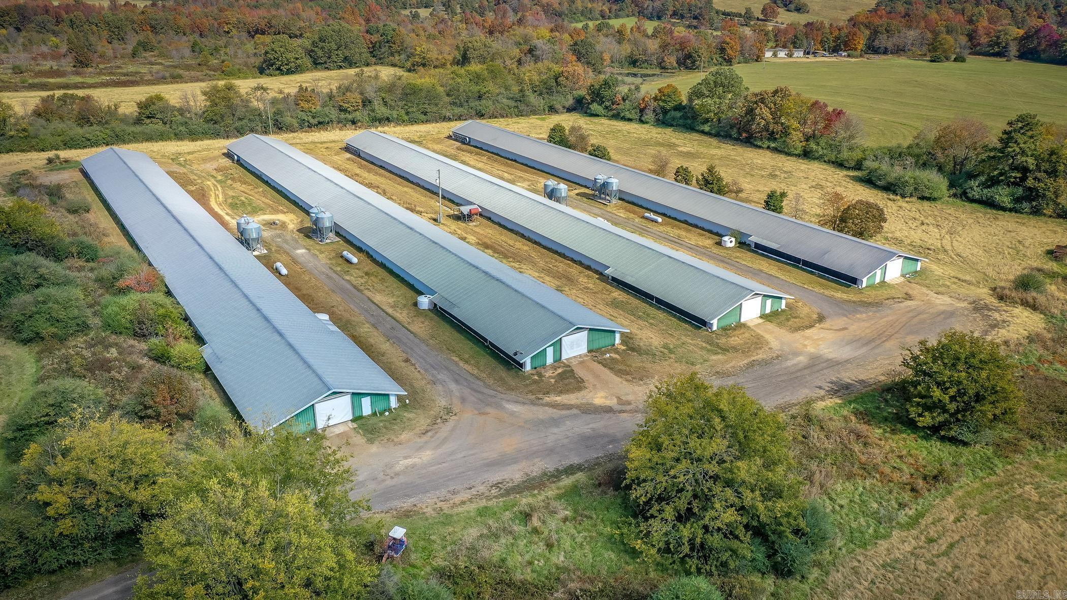 Here’s a great opportunity to work from home and enjoy the farm life! This beautiful 82-acre farm is fully fenced and cross-fenced, featuring 3 ponds and an old homestead. The property includes four 40 x 450 chicken houses and a spacious 5-bedroom, 3-bath modular home with a brand new HVAC system (2024). Inside, you’ll find plenty of room to spread out, plus an incredible hidden-door pantry in the kitchen. With fruit trees, rich pastures, and serene pond views, this property is ideal for those seeking a balance of work and farm living.