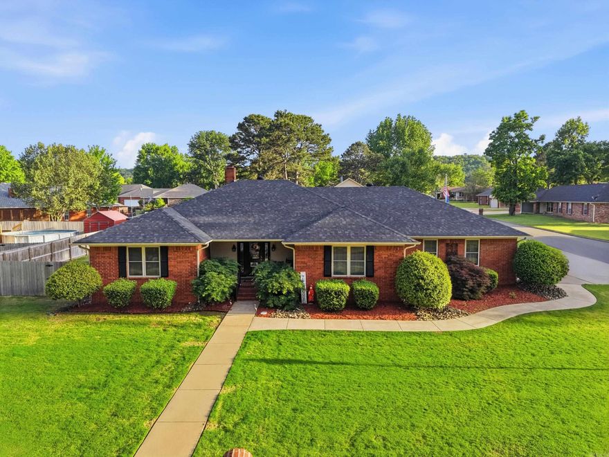 Located in one of Russellville’s popular neighborhoods near downtown, this well-maintained home sits on a large corner lot. The living room features a gas fireplace, while the oversized primary suite offers a soaking tub, walk-in shower, and heated floors. The kitchen includes stainless steel appliances, granite countertops, and a breakfast nook, with a formal dining room nearby. A spacious laundry room offers a half bath and extra storage. Enjoy the heated and cooled sunroom, covered patio, and fully fenced backyard with a rebuilt 12x16 shed. Additional features include a lawn sprinkler system, emergency generator, a roof replaced within the last 5 years, and a 50-gallon water heater upgrade.