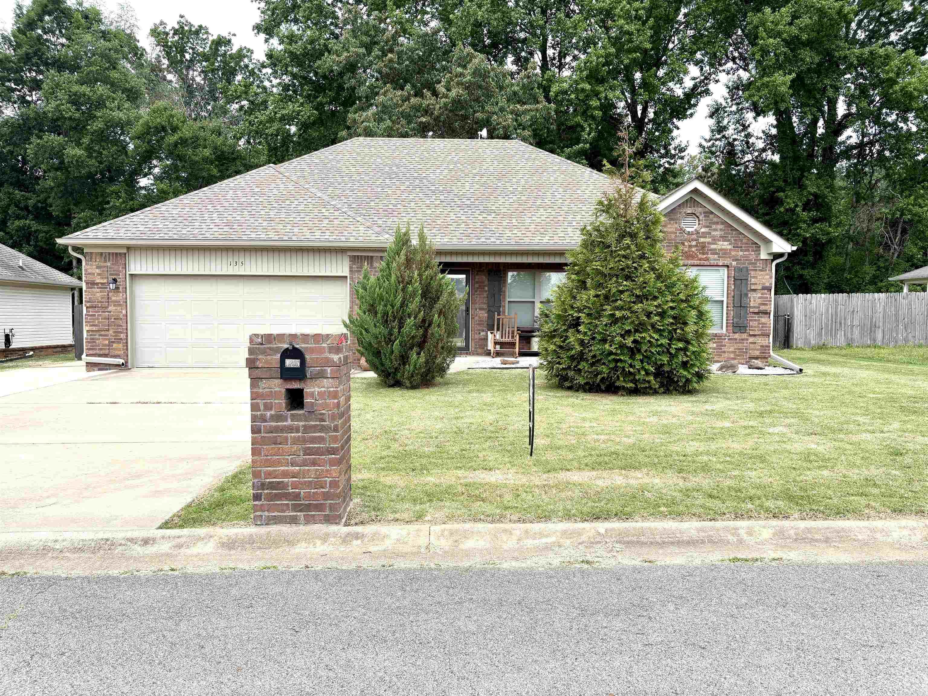 Immaculate, all-electric home with all the upgrades: Widened driveway and concrete barbecue area out back, side yard for RV parking, granite kitchen countertops and stainless appliances, including double oven. Living room has vaulted ceiling and arched doorway to the guest rooms. Primary suite is on the opposite end, with tray ceiling and walk-in closet. The back yard has a fire pit, covered patio and overlooks adjacent woodlands. In the back of the subdivision, there's little traffic and lots of charm. Better than new with mature landscaping and a lush lawn, it's move-in ready with a porch swing.