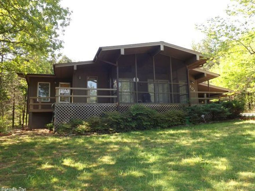 Wonderful one-level home with 2 roomy bedrooms, 10x16 bonus room , 1 1/2 baths, open living room/dining across the front of the home with vaulted ceiling, wood burning fireplace, and patio windows/doors all across looking onto the very nice screened porch with decks on either side,  very updated kitchen with beautiful cabinets and appliances, drywall with panel accent interior, wonderful hardwood flooring throughout (great for those with allergies), wood siding exterior, double pane windows, 2006 shingles.