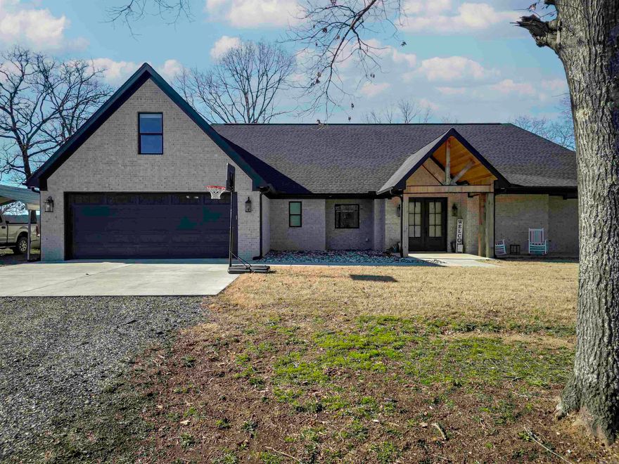 Welcome to this fantastic all-brick home on acreage in a peaceful country setting and located in Benton School District. Upon entering through lovely double doors, you will appreciate the spacious living room with beautiful wood floors, brick fireplace, and custom built-ins. The family space continues into a kitchen that is a chef's dream, with a huge island, farmhouse sink, and large walk-in pantry. A half bathroom just off the kitchen is perfect for entertaining. The master suite is spacious and the master bath is outfitted with a double vanity, large tiled walk-in shower, and his/her closets. There are an additional two bedrooms and another bathroom, also with double vanities and a spacious upstairs bonus room. This 2021 built home also features a built in safe room, and a large, covered back patio with a vaulted ceiling. Sitting on nearly 7 acres, there is plenty of room to roam the outdoors. There is a barn and livestock fencing on the property as well.