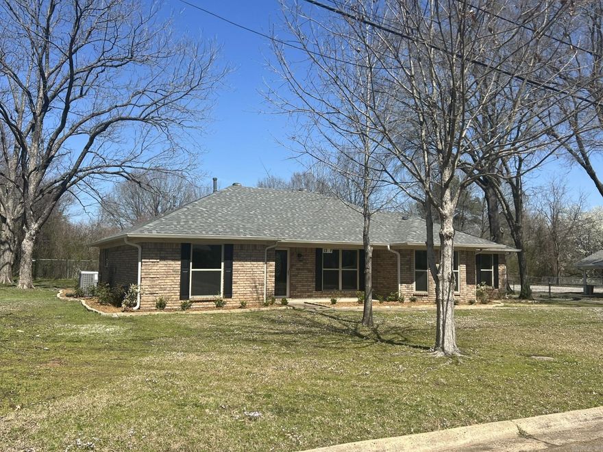 A TOTAL MAKEOVER! Everything is new: Roof, Windows, Gutters, landscaping, flooring, cabinets, appliances, granite countertops, paint, light fixtures, door knobs, mirrors, toilets, 2 new (gas) water heaters, walk-in shower, electric fireplace. Beautiful kitchen with stainless steel appliances, Coffee bar area or appliance center, breakfast bar & eating area. Formal dining could be used as a 2nd living or an office. Large family room in the center of the home with cathedral ceiling w/ wood beams & a brand new electric fireplace. Large pantry in the laundry room plus storage above the washer & dryer space. Main suite has a spacious bath with a new walk-in shower, double vanities, sitting space between the sinks & a large walk-in closet. Opposite side of the home offers 2 spacious bedrooms & guest bath. There is a double carport attached on the back with lots of attached storage space behind the carport. This all sits on over 1/2 acre lot inside the city limits. Owners are licensed Realtors in Arkansas.