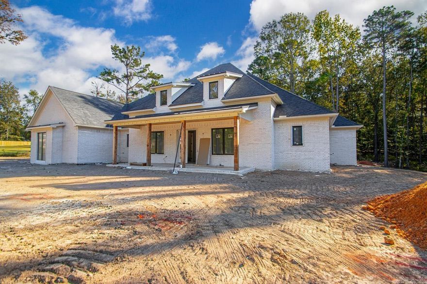 Beautiful New Home in the Scenic Hazel Oak Subdivision... Amenities include: Approximately 3892 Square Feet, 5 Bedrooms, 4 1/2 Bathrooms, Living/Dining Combo, Kitchen/Dining Combo, Open Floorplan concept, Split Bedroom Floorplan, 4 Bedrooms Down, Bonus Room/5 Bedroom upstairs with full bathroom and closet, Large Primary Bedroom, Primary Bathroom has walk-in custom tile shower and separate free standing tub, Living Room with Fireplace, Kitchen has an abundance of cabinets - large island - Breakfast Bar - gas range - double wall oven, Nice Pantry, Large Laundry Room with cabinets and sink, Office, Safe Room built in to closet, Front Sitting Porch, Large Covered Patio, Sitting on nice Tree Shaded 1.47 acre lot +/-, And Much More.... This is Truly a Custom Built Home... A Must See....
