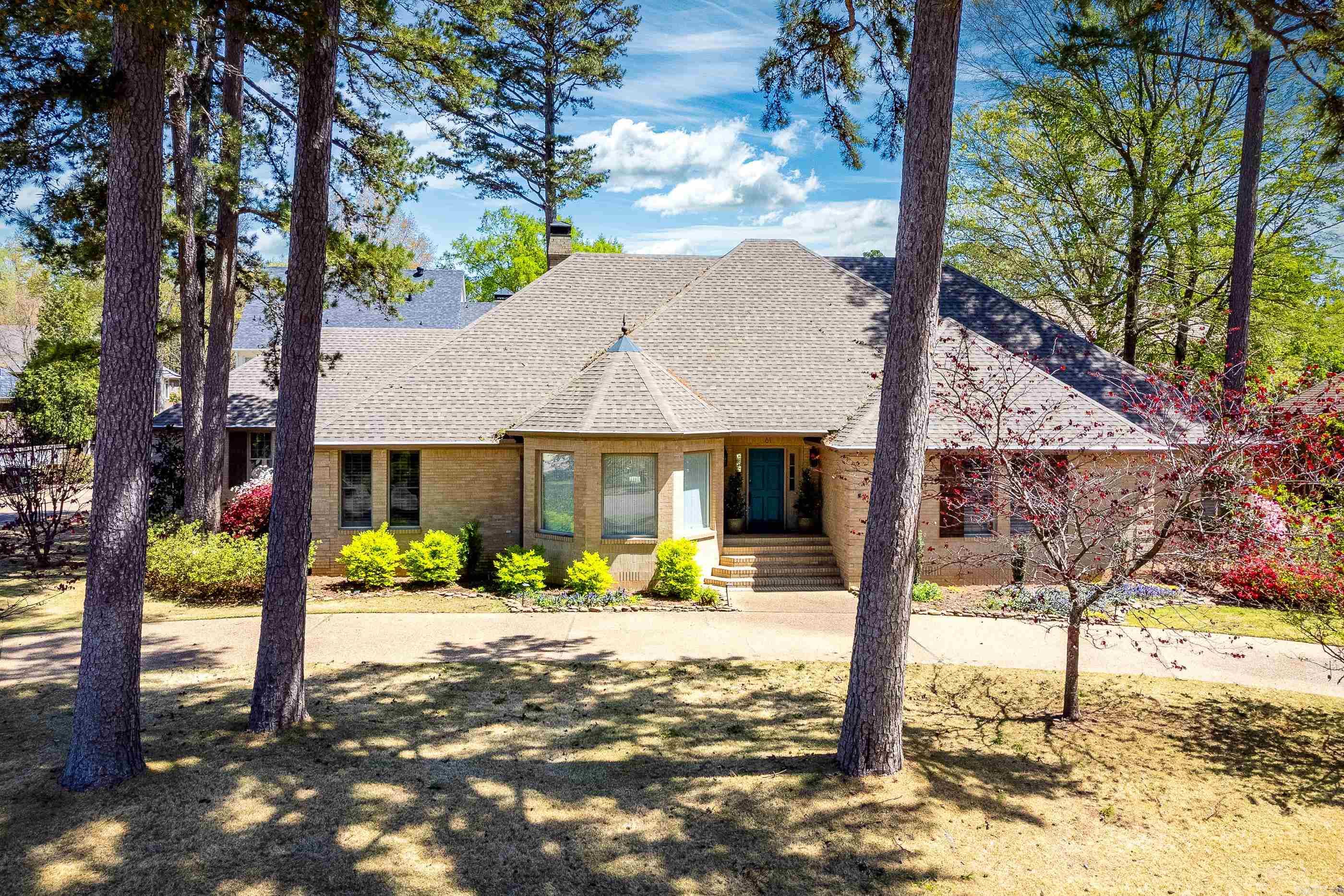 Beautiful one level brick home on desirable Chenal Circle. This well maintained property features stunning hardwood floors throughout and a spacious, light-filled layout. The huge eat in kitchen features abundant custom cabinetry, granite countertops, gas range, and stainless steel appliances. Enjoy entertaining in the formal dining room and the expansive great room, which showcases a coffered ceiling, built-ins, wet bar, and an impressive gas log fireplace all framed by a wall of windows. The generous primary suite offers a luxurious bath with jetted tub, updated finishes, and two closets. Two guest bedrooms also share a updated bath, while a fourth bedroom/office is located near a third full bath. A large laundry room with extra storage adds convenience. Enjoy outdoor living with a covered patio, large decks, and a fenced yard with updated gates. Additional updates include fresh interior paint, new gutters, fencing, fixtures, and more. Two car garage. Come see!