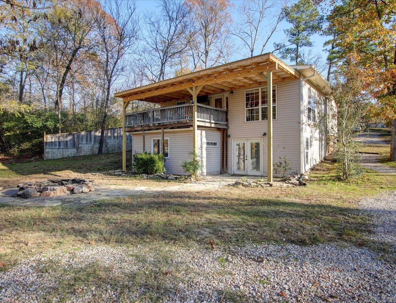 Recently updated 3 bed 2 bath move in ready home in Lake Hamilton School District. Large open concept living/dining room is perfect for family gatherings. French doors lead to the spacious covered balcony with a new awning that spans the entire width of the house. The kitchen has plentiful cabinetry with stainless steel appliances. Enjoy a private oversized master suite downstairs with french doors opening to the firepit in the backyard. The master suite features a cedar lined walk in closet, office, and bathroom with soaker tub, shower, 2 individual vanities. The roof has also been replaced with new architectural shingles within the past year.