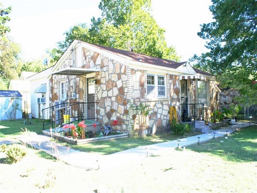 Neat as a pin. Old smooth rock and vinyl. Has covered deck, fenced yard, new wall furnace, window A/C's, and an efficiency apartment in the back.