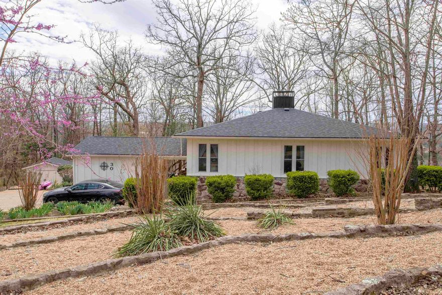 Stunning Ozark Home with Seasonal Lake Views! Discover your dream retreat high on a beautiful plateau in the Ozarks of Arkansas! This completely renovated 4-bed, 2-1/2 bath home offers breathtaking seasonal views of three lakes and is nestled on 1.8 acres of nature's paradise. Renovated in 2022, this property features a 2022 Roof, 2022 HVAC system, & luxury plank vinyl flooring throughout. The main level approx. 1,330 sq ft, showcasing a stunning kitchen equipped with quartz countertops, new cabinetry, and updated appliances, including a convenient pot filler faucet above the cooktop. The living room, adorned with an electric fireplace, provides a warm and inviting atmosphere for relaxation and gatherings. The main level consists of 3 bed and 2 beautifully updated baths, ensuring ample space for family and guests. Descend to the basement level, which offers 720 sq ft, including a large family room with an electric fireplace, a cozy bed, a 1/2 bath, and a laundry area—perfect for visitors. expansive back deck that stretches the full width of the house on the west side, ideal for sunset views. Redbud trees among hardwoods provide natures habitat to birds and wildlife. 12X12 workshop.