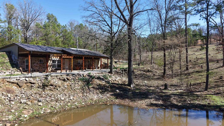 Secluded Home on 10± Acres in North Central Arkansas – Barn, Pond & Airbnb Potential Discover peaceful country living with this unique 2 bedroom, 1.5 bath partially underground home sitting on 10± acres in North Central Arkansas. Built for durability and efficiency, the home features 6-inch poured concrete surrounding the structure with 3-inch center block support walls, providing excellent insulation and strength. The partially underground design helps maintain comfortable temperatures year-round, keeping utility costs low. The home offers concrete floors, oak kitchen cabinets, brand-new appliances, cedar bathroom doors, and a cedar cabinet in the main bathroom. A new fireplace in the bedroom adds warmth and charm, while additional updates include new windows, gutters, and a new roof installed in 2025. The home also includes city water, septic system, WiFi, hot water heater, and laundry room. The 10± acres provide privacy and room to roam, with a wet-weather pond. A barn with electricity for storage, or a workshop. The Land is partially fenced.  The property has been well maintained and successfully used as an Airbnb since 2024, Priced to sell at $169,900