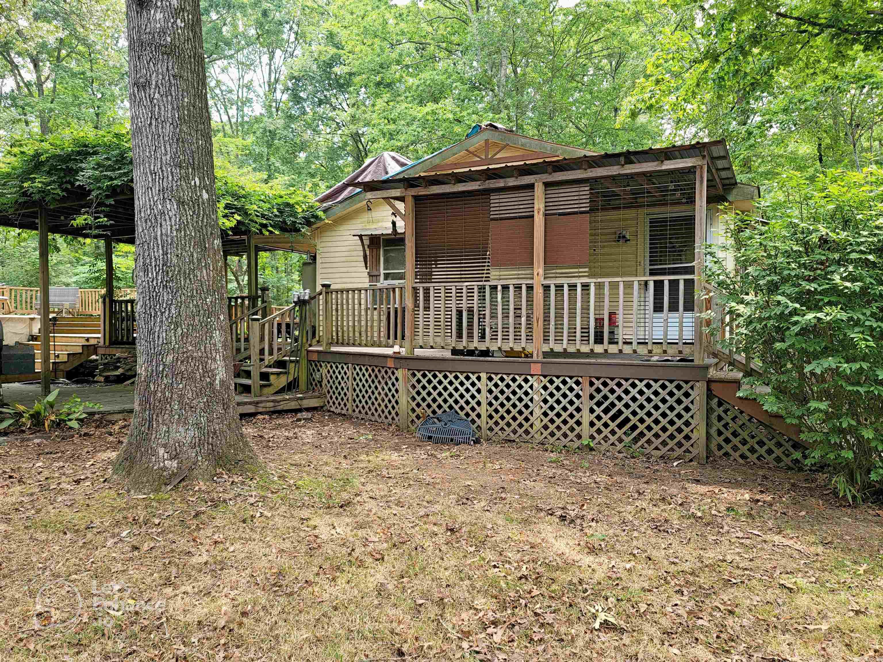 Come check out the large deck surrounding the house and the above-ground swimming pool. There is so much deck to this house! The roof needs some work due to storm damage. Come see the property to see if you can handle the repairs. You'll see the damage to the ceiling in one of the photos. The seller has priced this to sell quickly. (The Zestimate and other Automated Valuation Models apparently don't take into account the large workshop.)