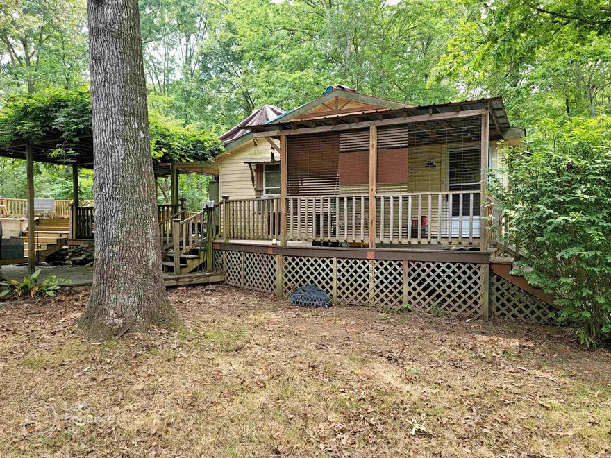 Come check out the large deck surrounding the house and the above-ground swimming pool. There is so much deck to this house!  The roof needs some work due to storm damage. Come see the property to see if you can handle the repairs. You'll see the damage to the ceiling in one of the photos.  The seller has priced this to sell quickly.  (The Zestimate and other Automated Valuation Models apparently don't take into account the large workshop.)